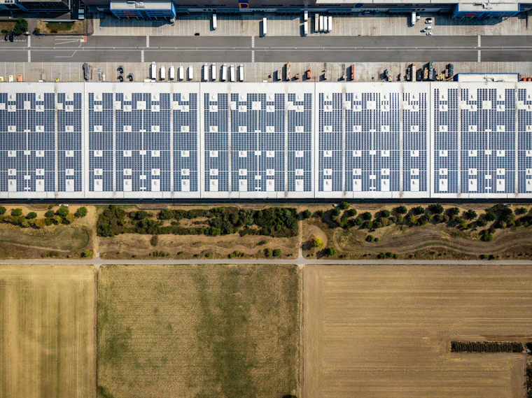 Vista aérea de telhado de galpão comercial coberto por módulos fotovoltaicos