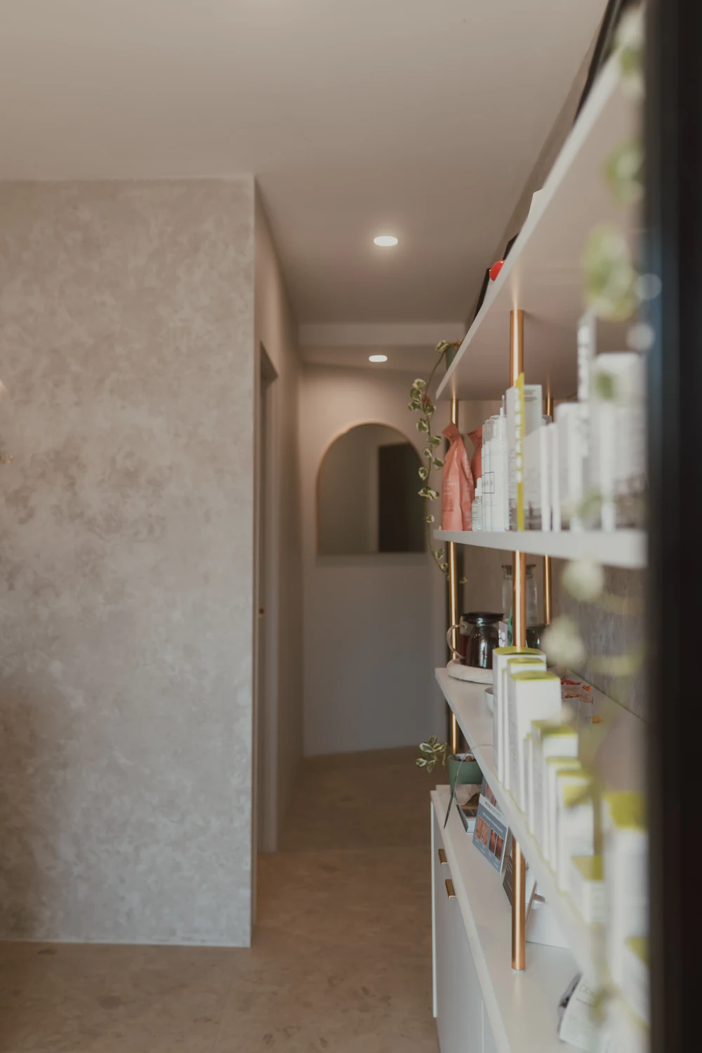 Bright clinic hallway with shelves of skincare products