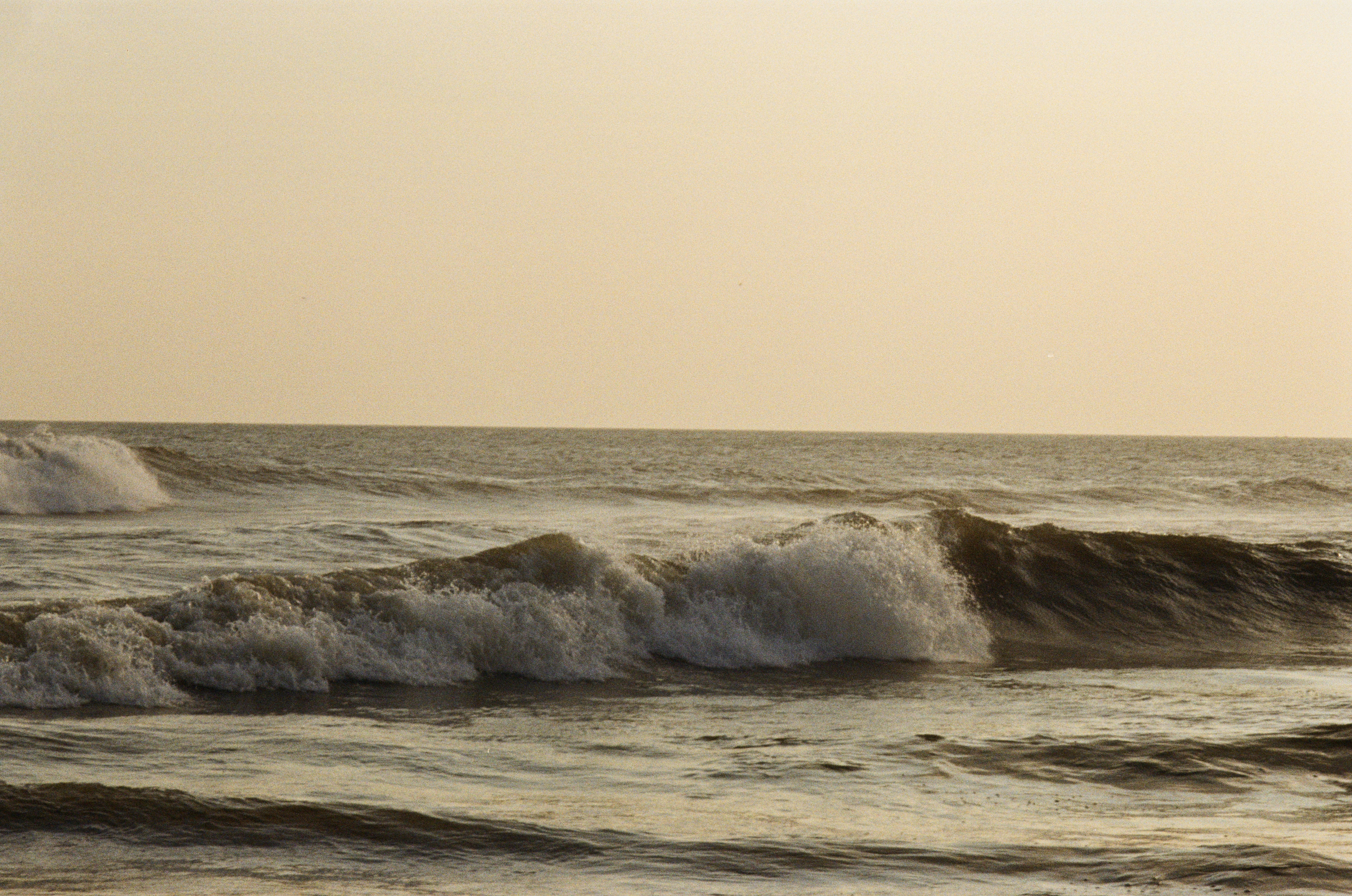 Ocean waves breaking in the golden light of a low sun