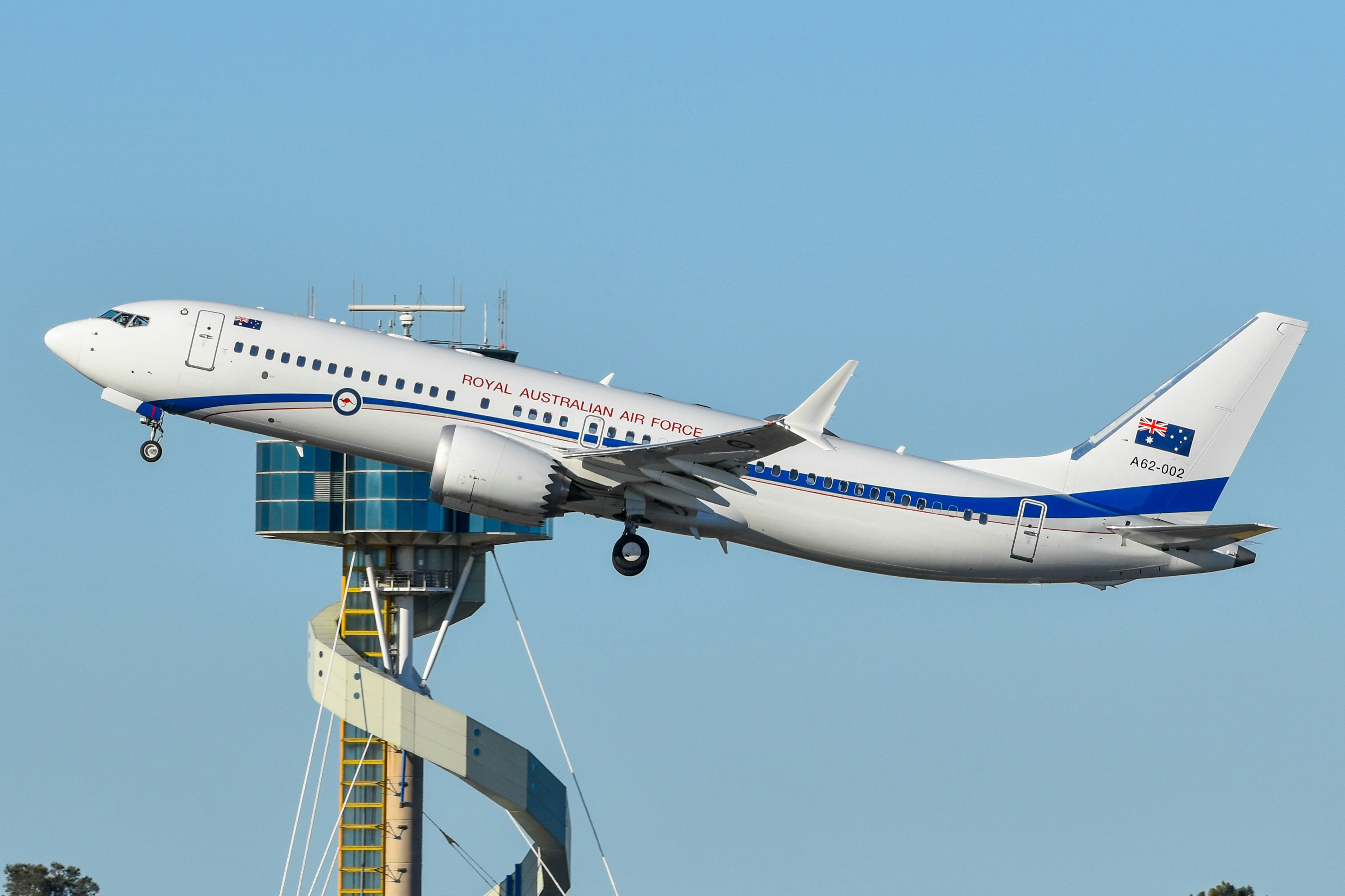 A Royal Australian Air Force Boeing 737 aircraft taking off above a control tower