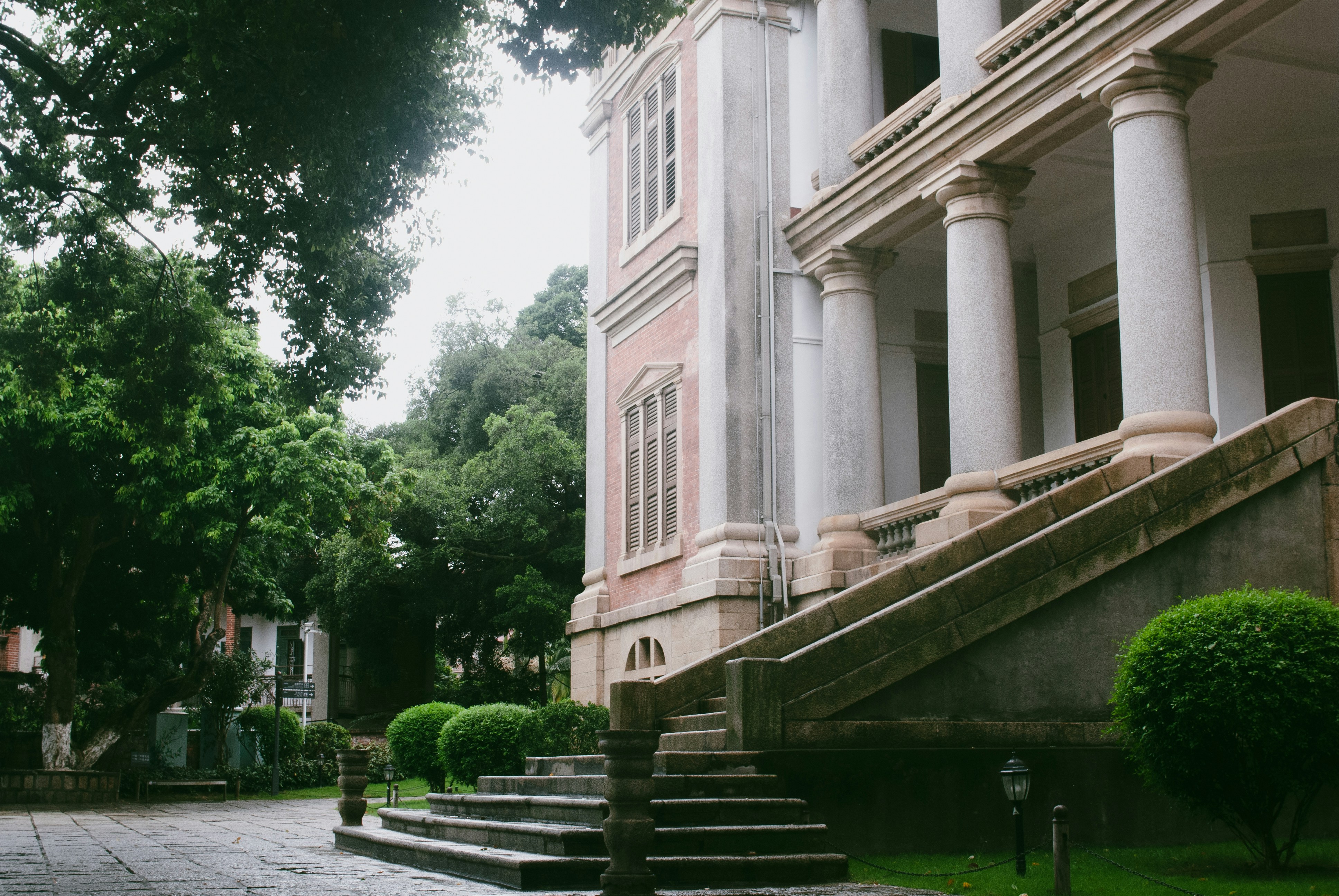 Historic building with white columns and garden steps