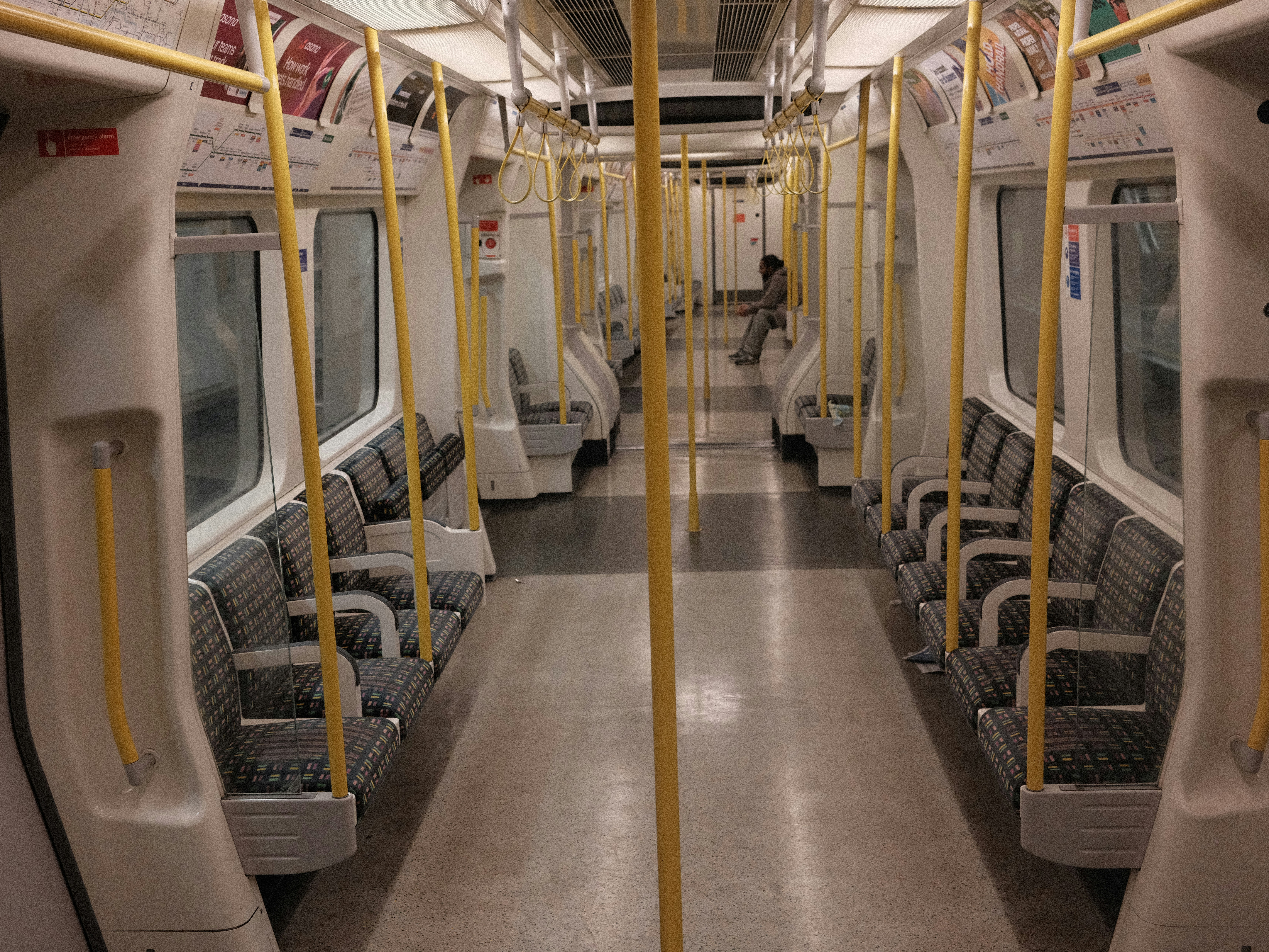 Empty train carriage with yellow poles
