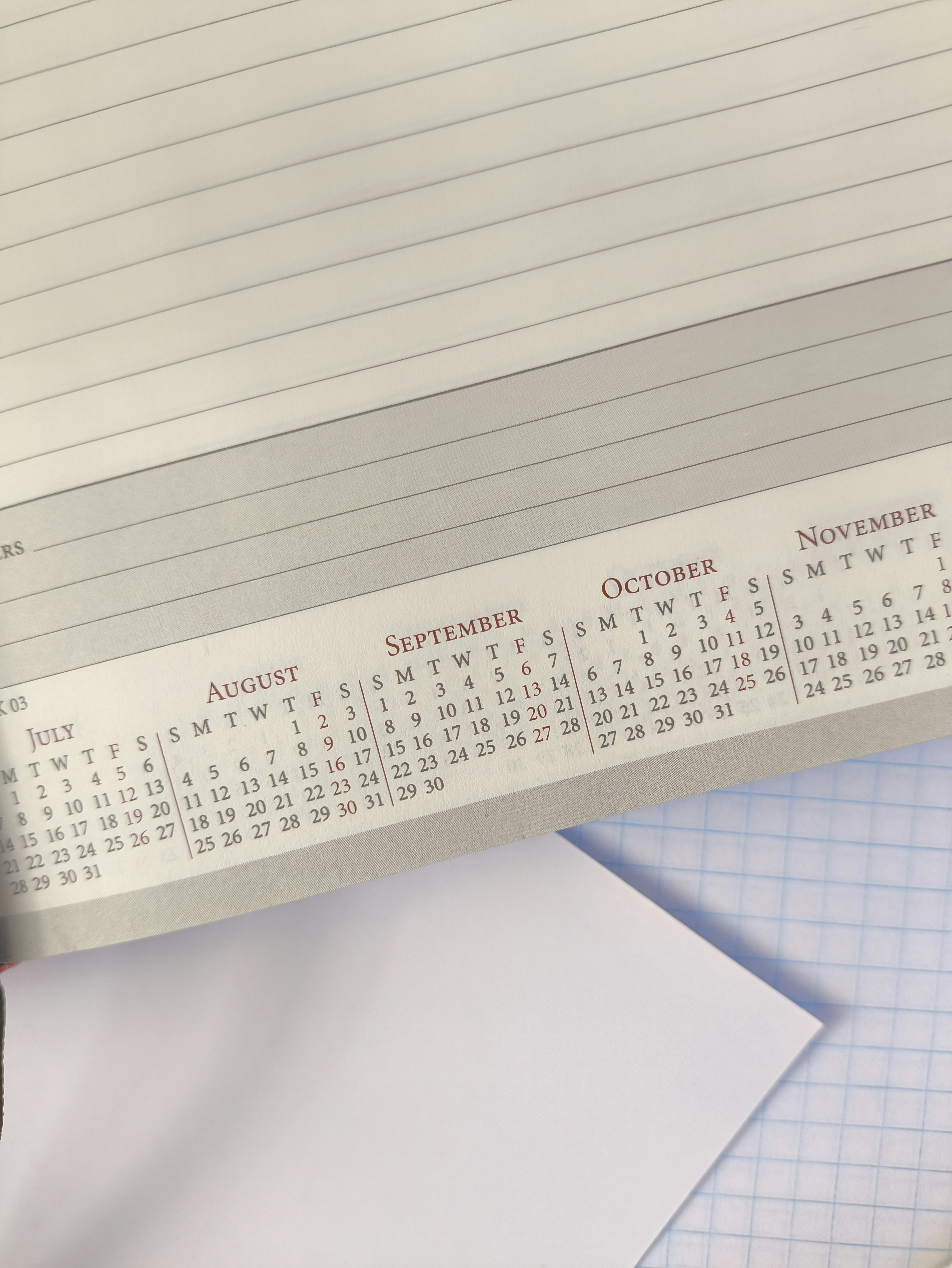 A printed calendar page showing months from July to November on lined paper