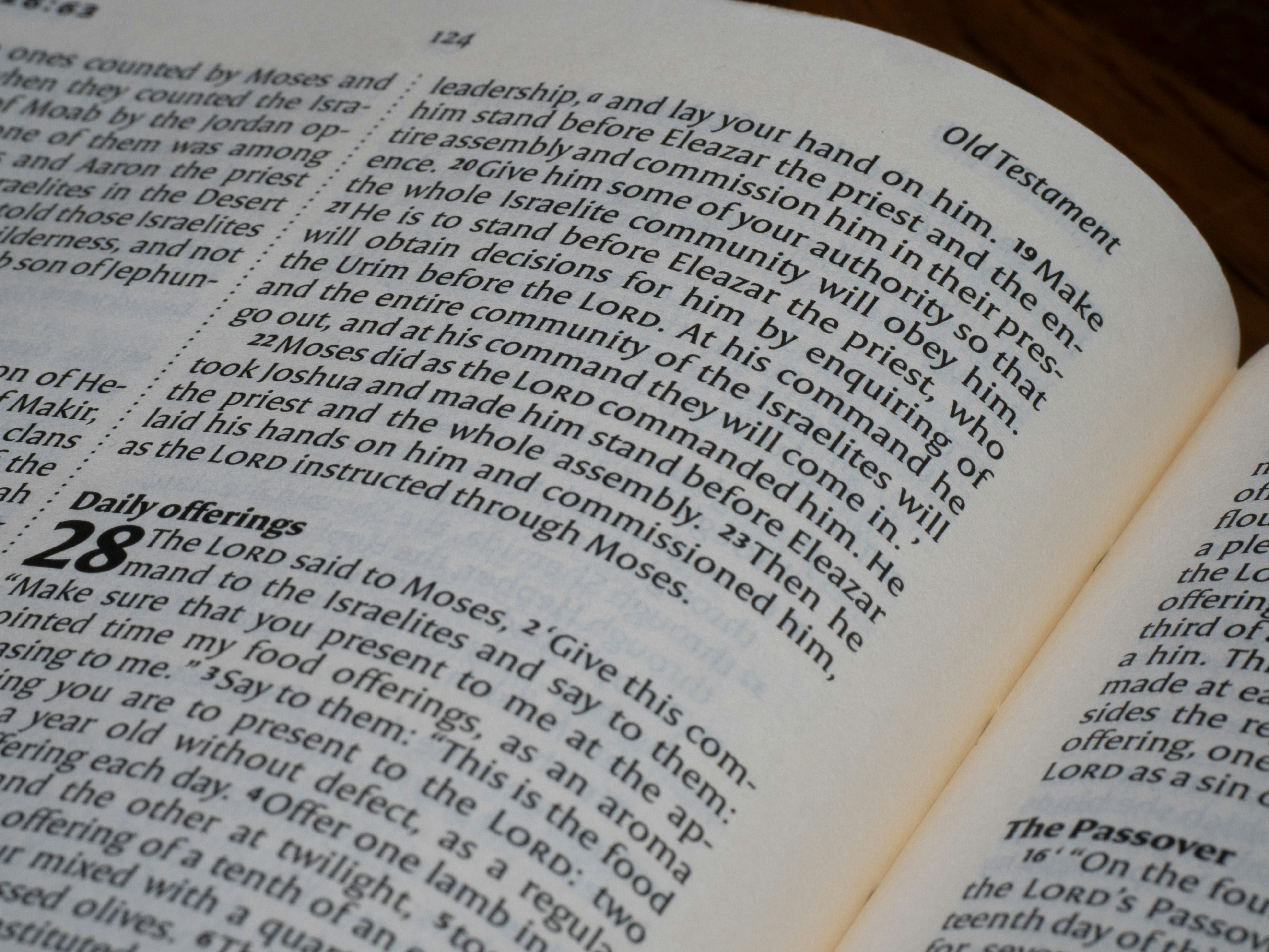 An open book with printed text from the Old Testament on paper pages