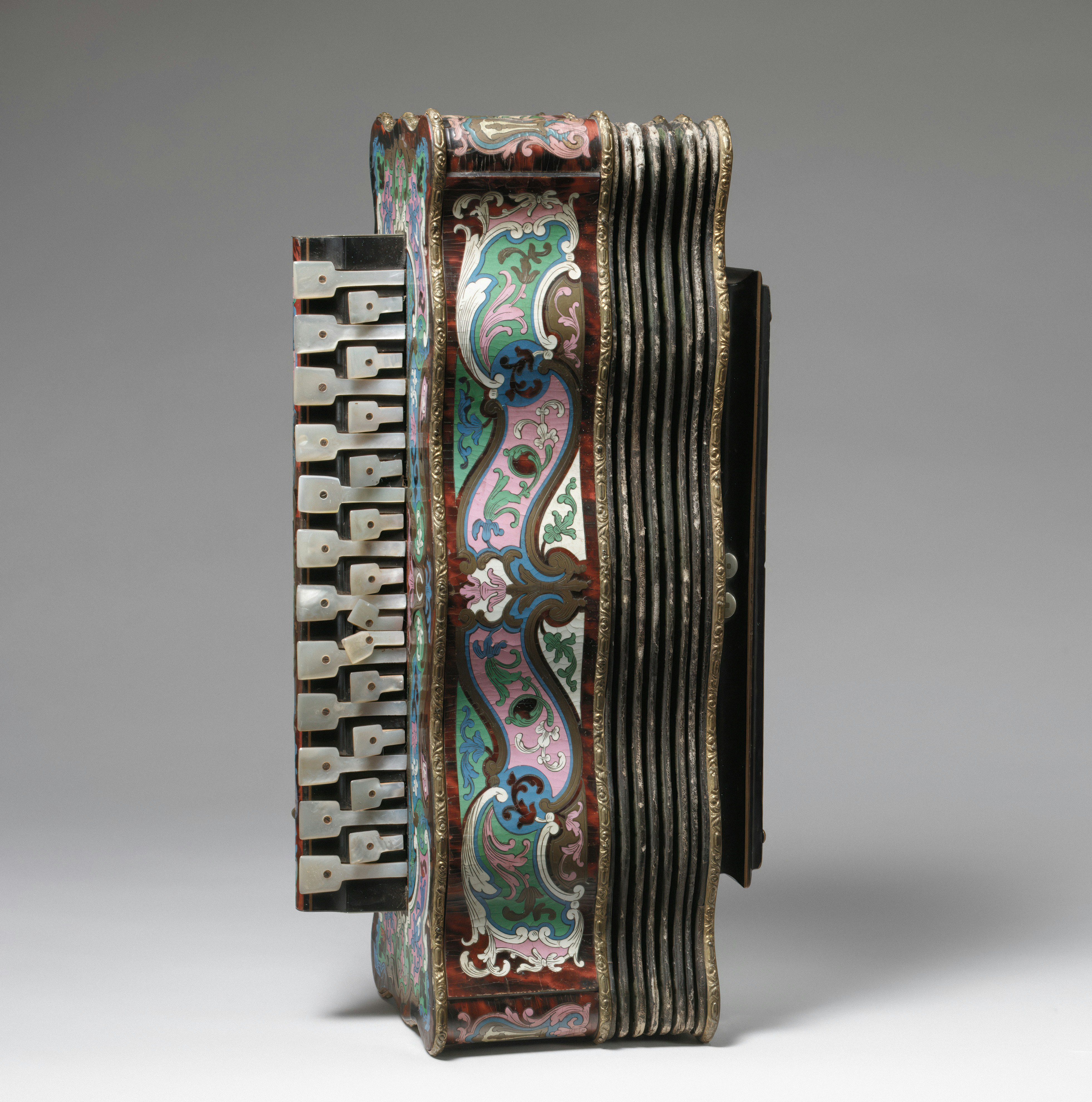 musette: An ornate accordion with mother of pearl keys and colorful floral enamel patterns