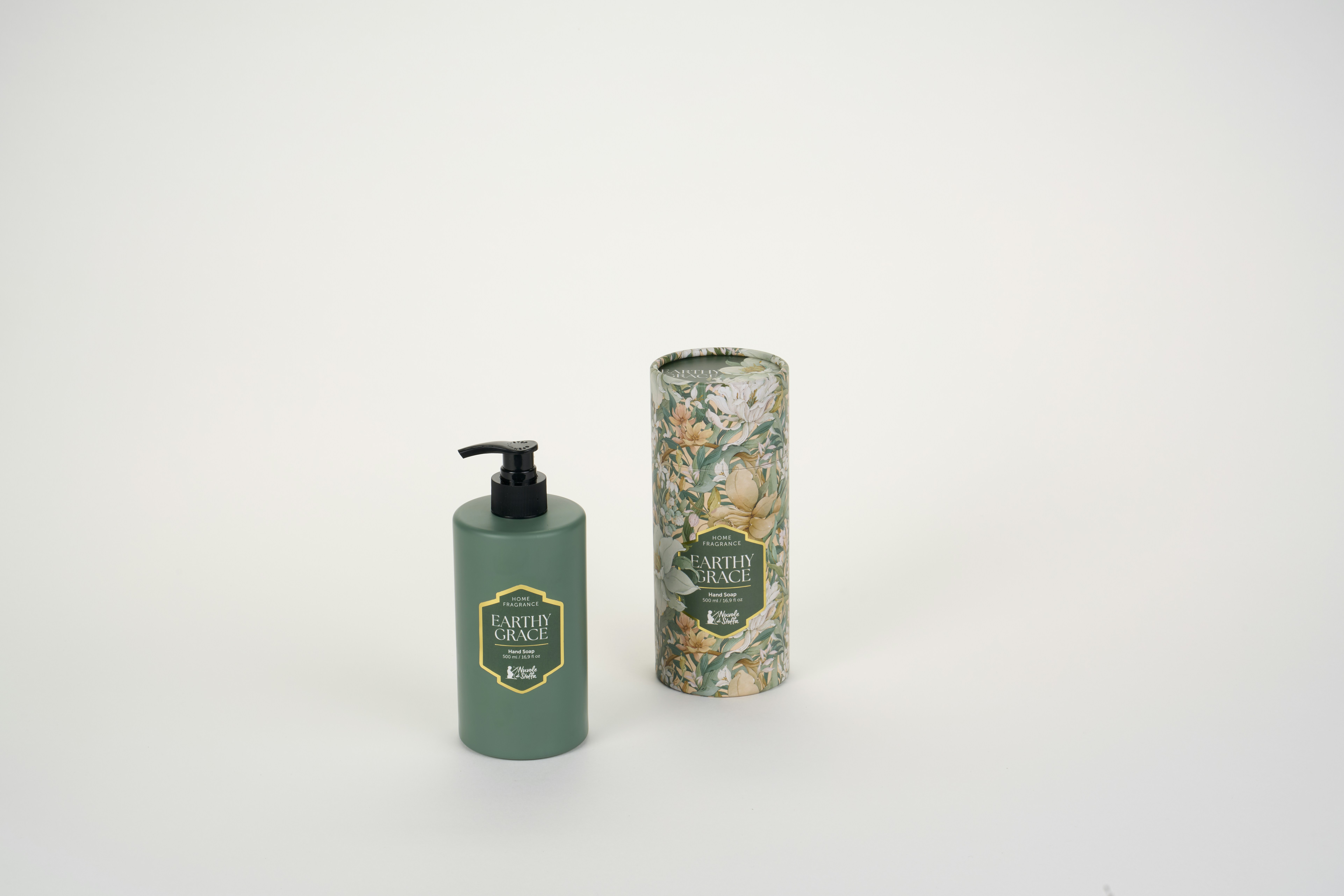 A green hand soap bottle and a floral patterned cylindrical box