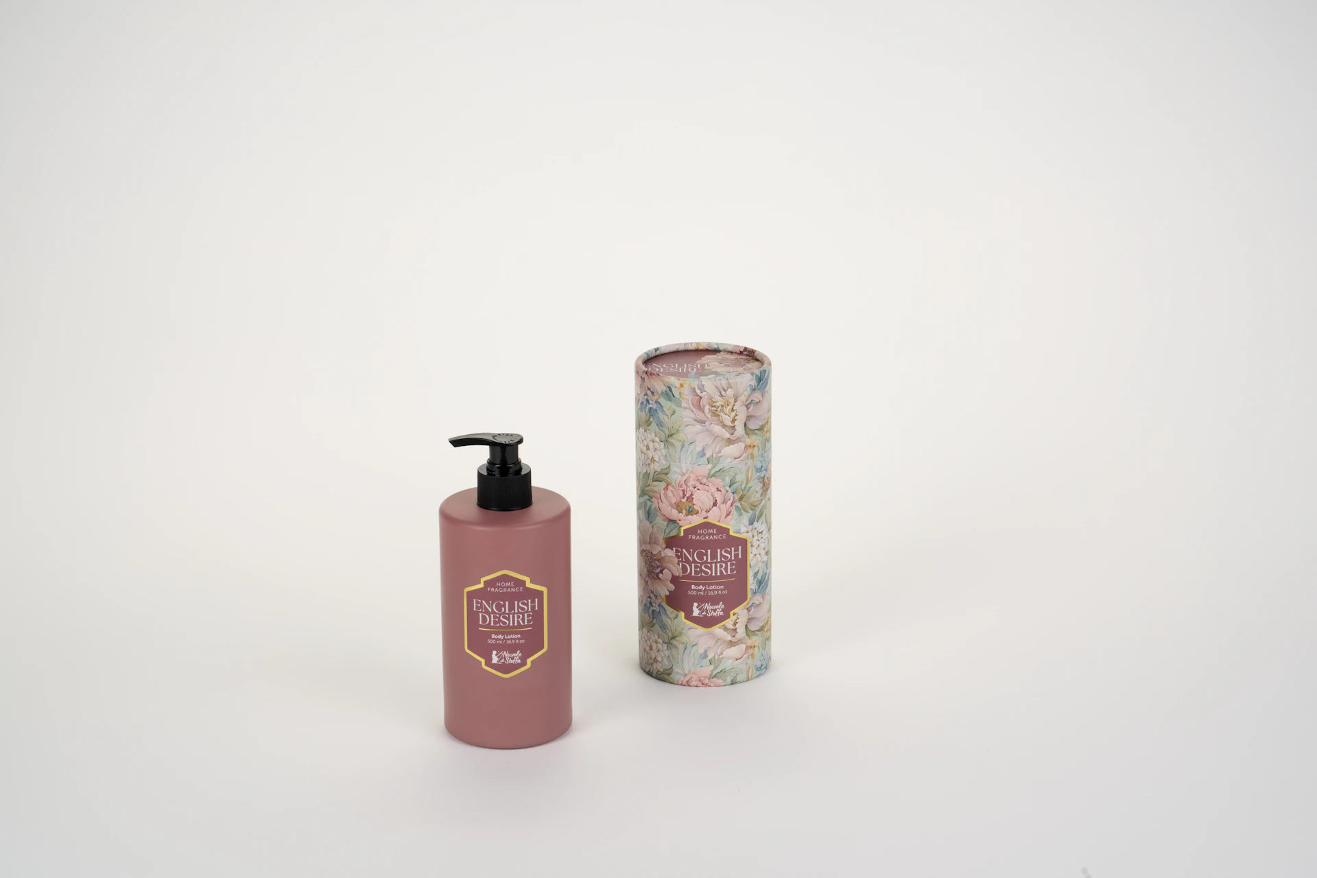 A pink pump bottle of body lotion beside a matching floral cardboard tube