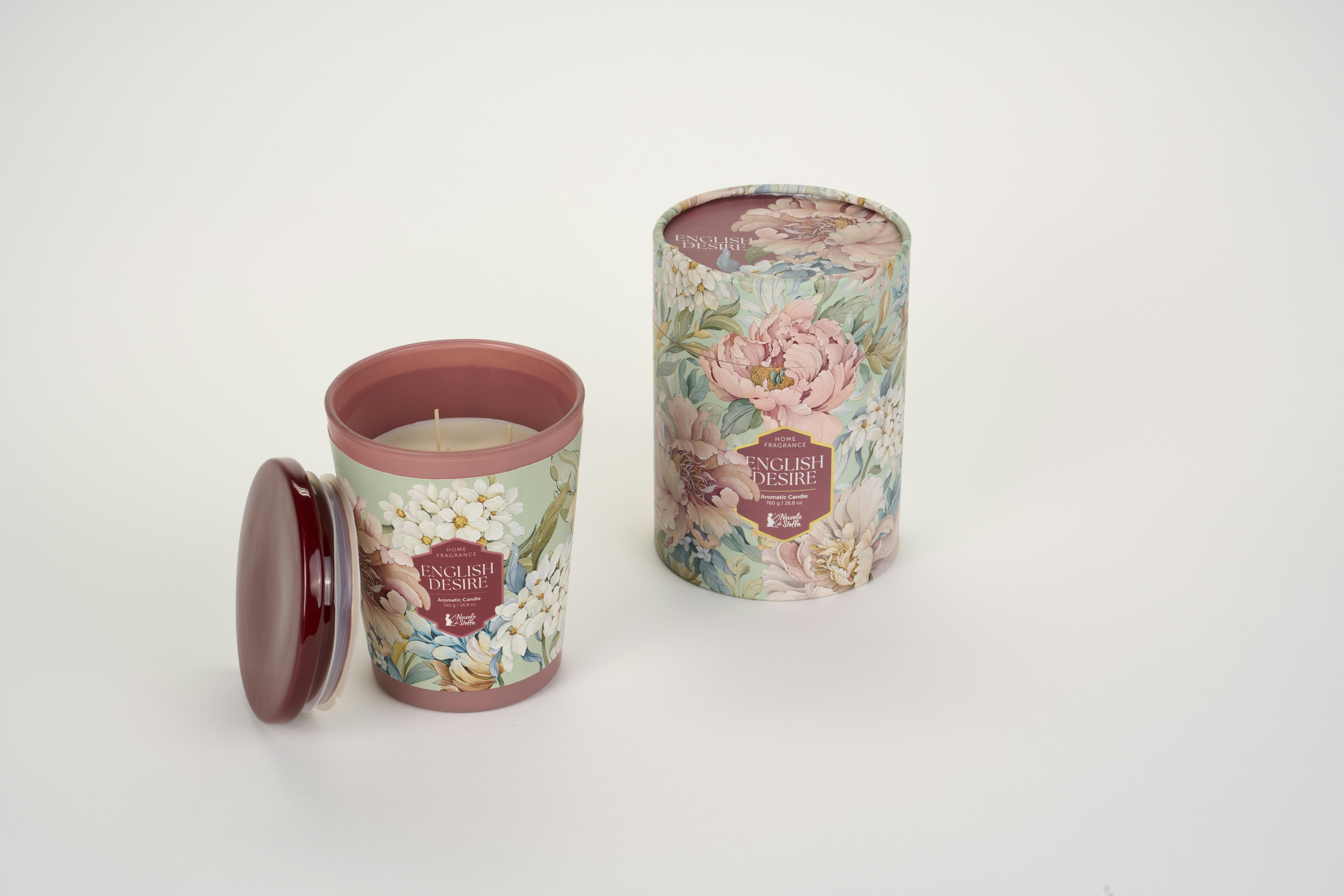 A floral scented candle in a patterned jar with a matching cylindrical box