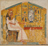 A woman in a white dress sitting and playing a board game