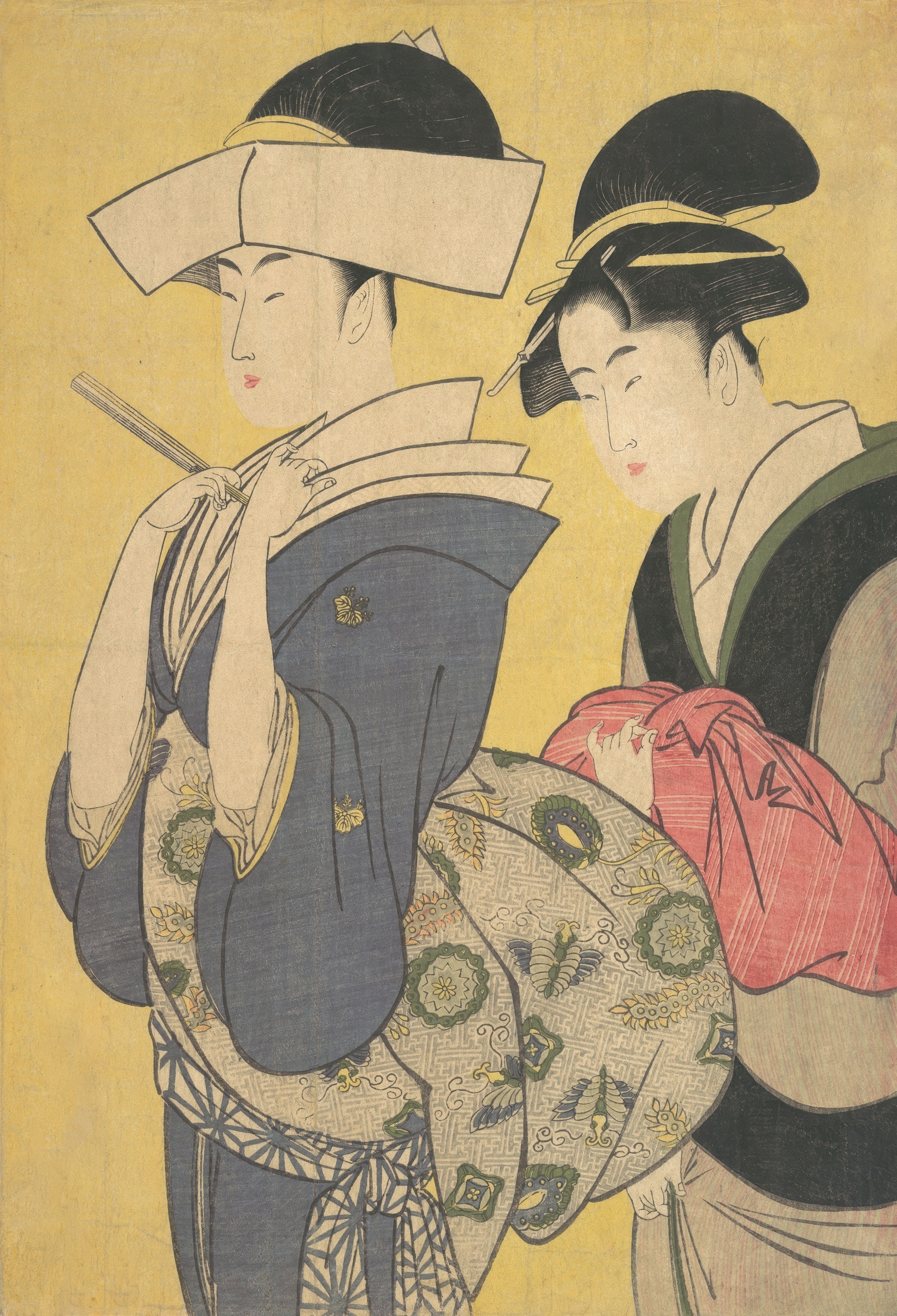 Two women in traditional Japanese clothing with elaborate hairstyles against a yellow background