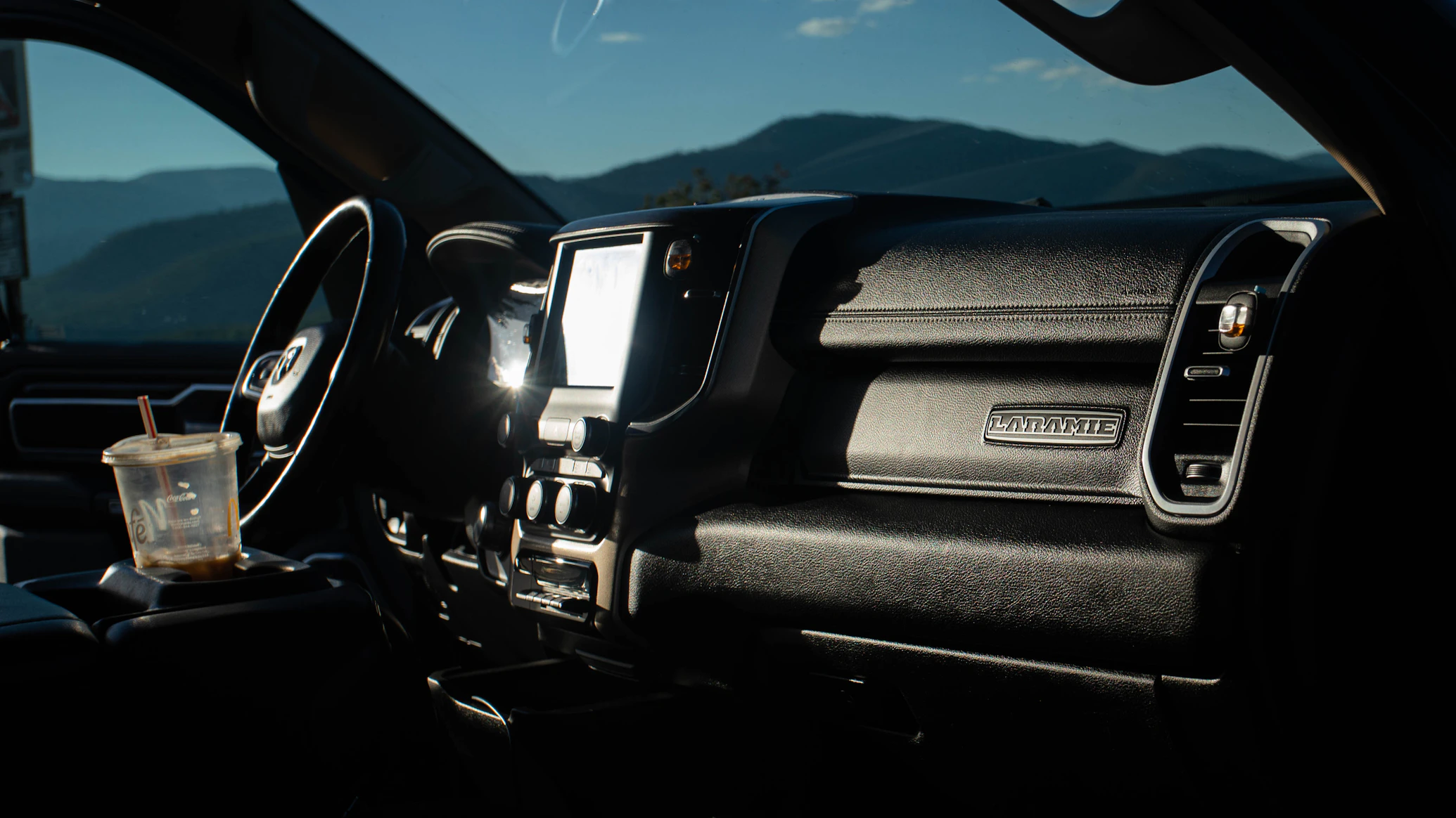 Truck cab dashboard and steering wheel, representing life on the road for owner-operators and drivers