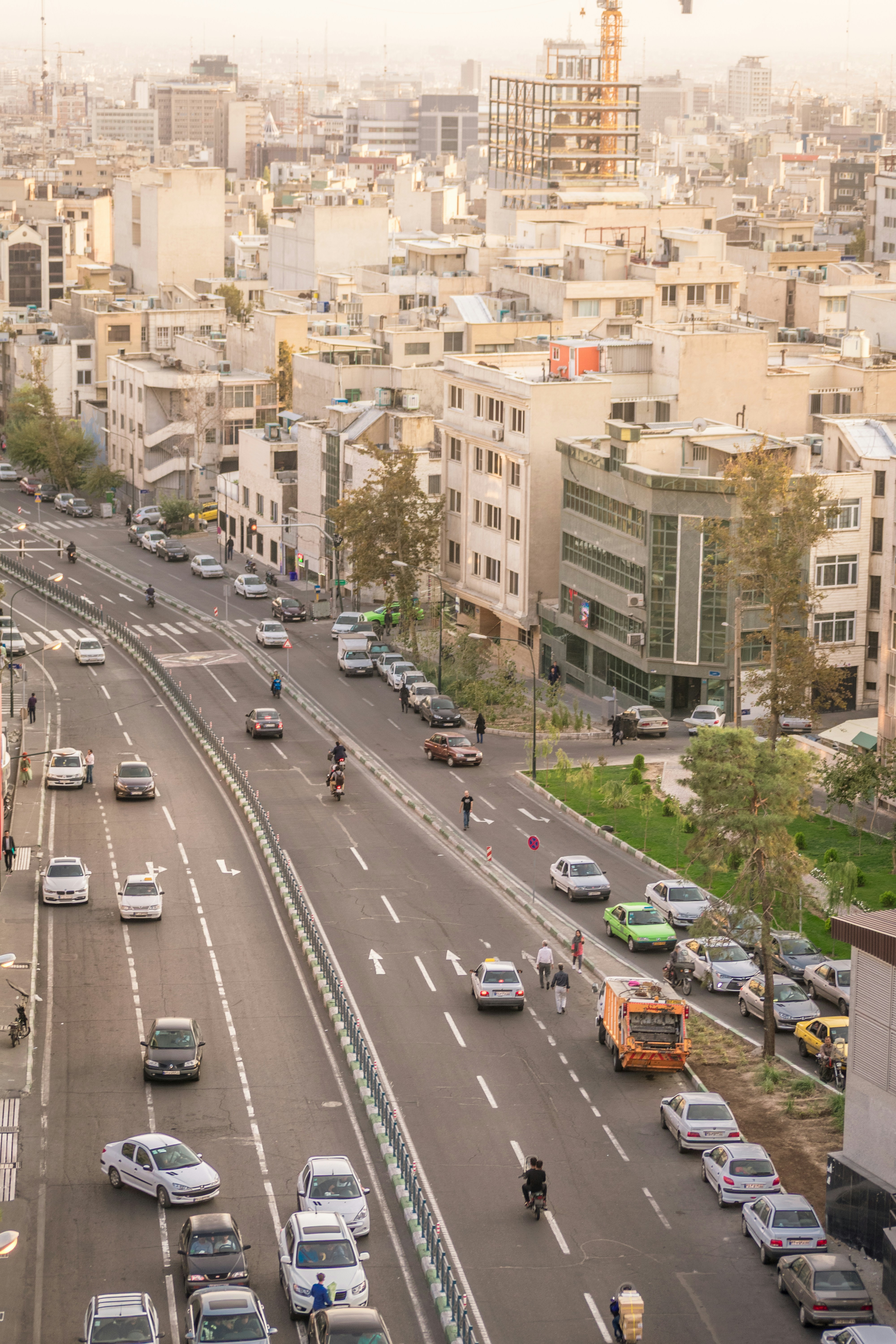 An aerial view of a multi-lane city street with cars and motorcycles in Tehran