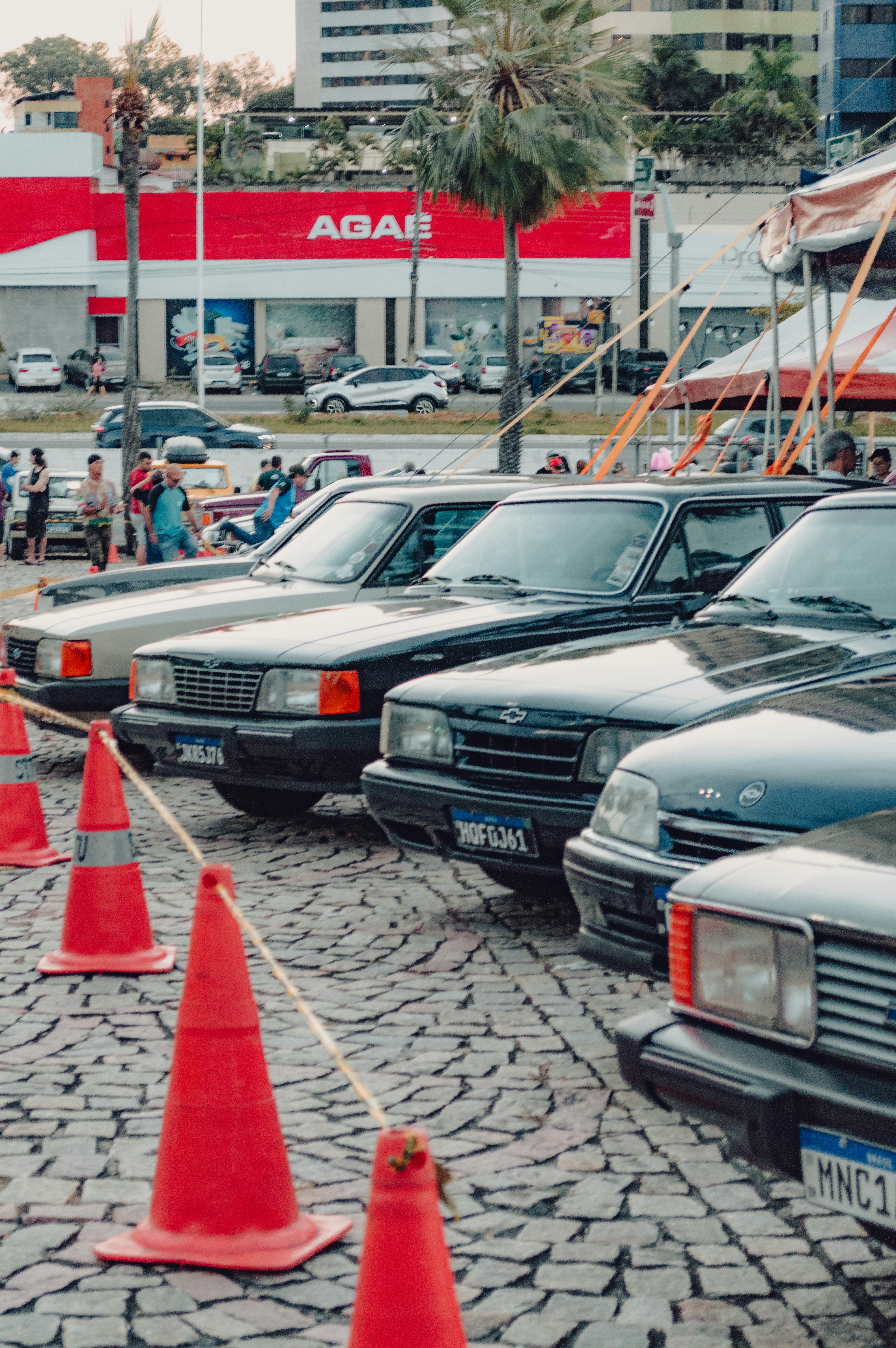 A row of vintage Chevrolet Opala cars parked on a cobblestone street