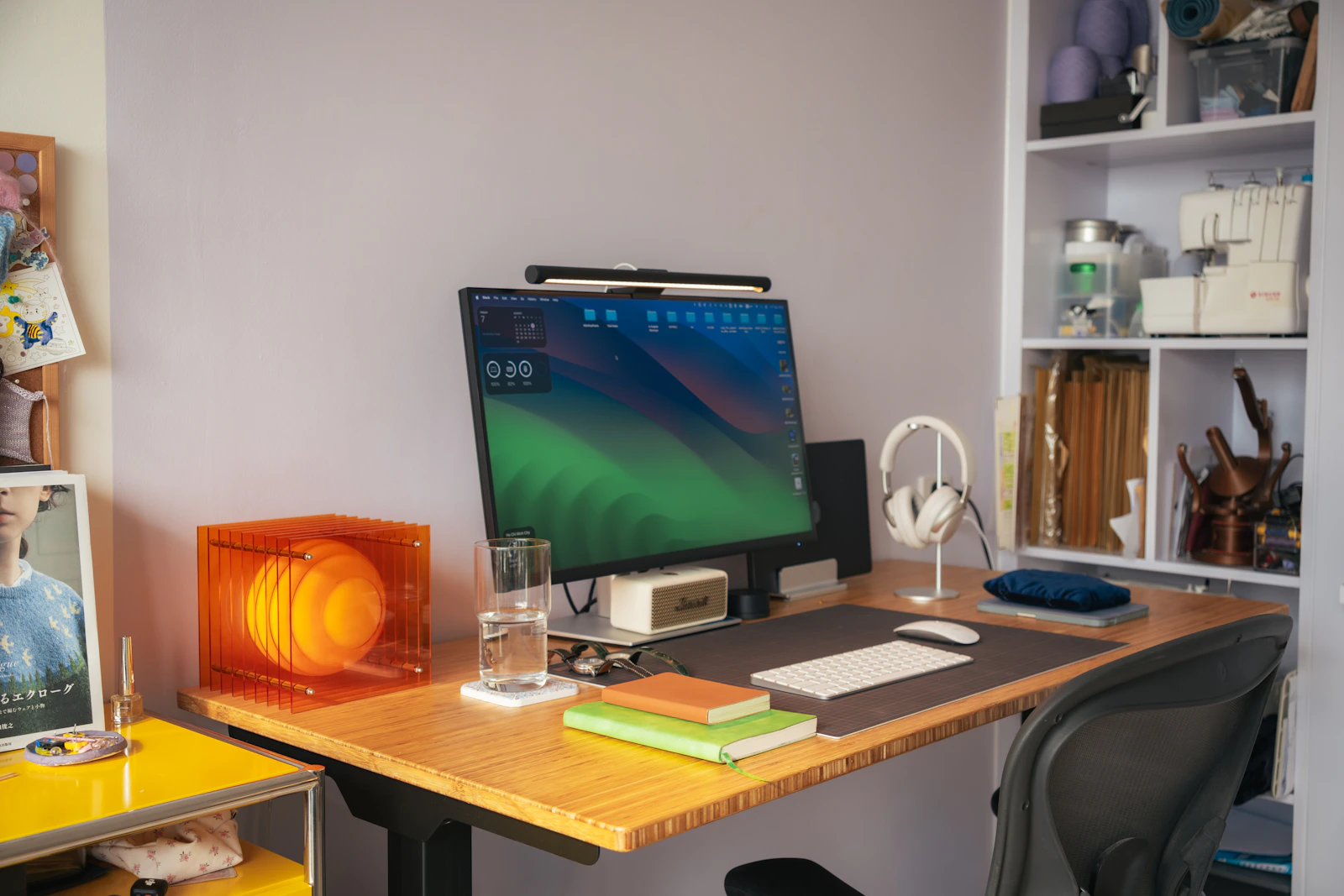 Modern home workspace with monitor, keyboard, speaker and headphones