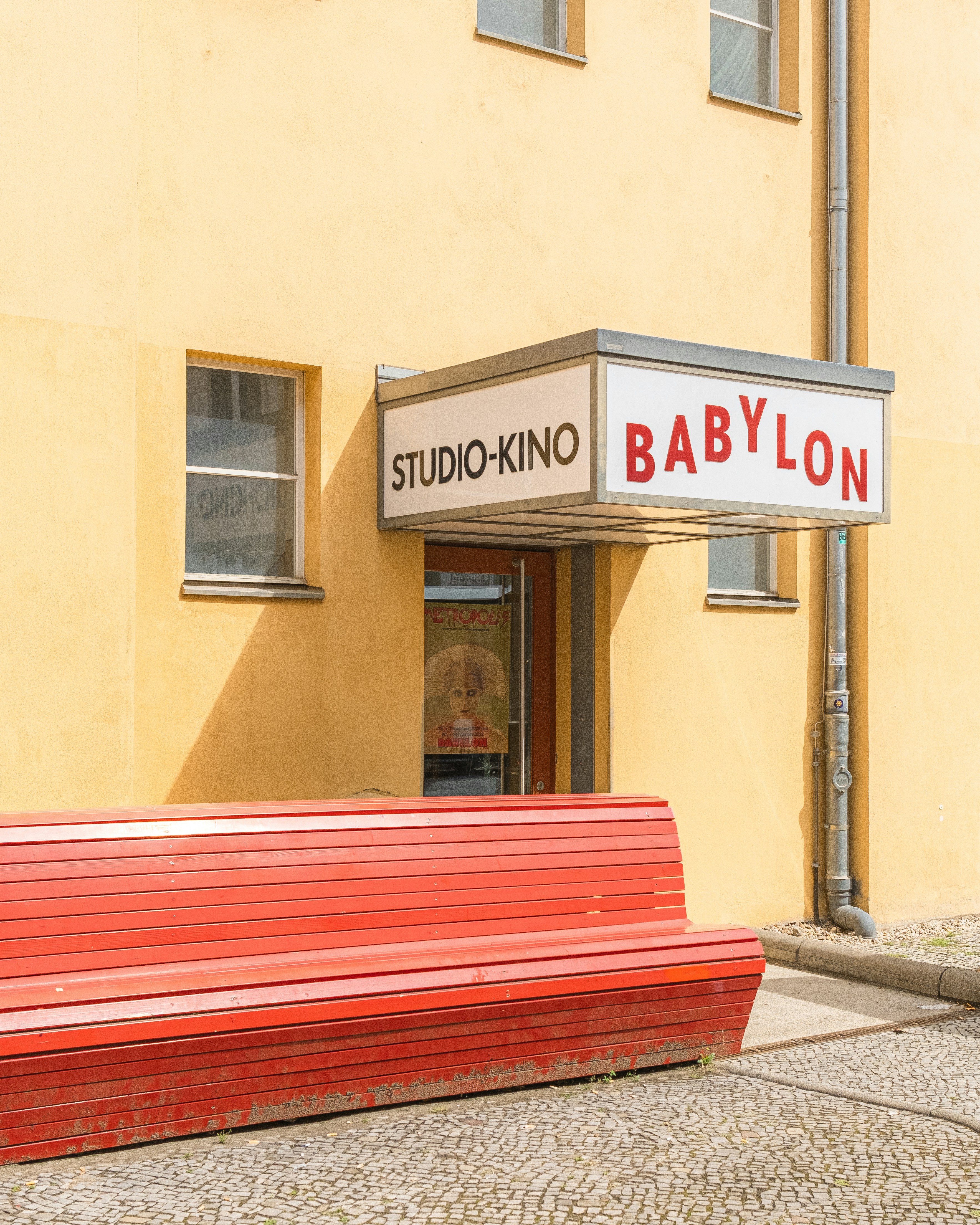 A red bench in front of the Studio-Kino Babylon cinema in Berlin