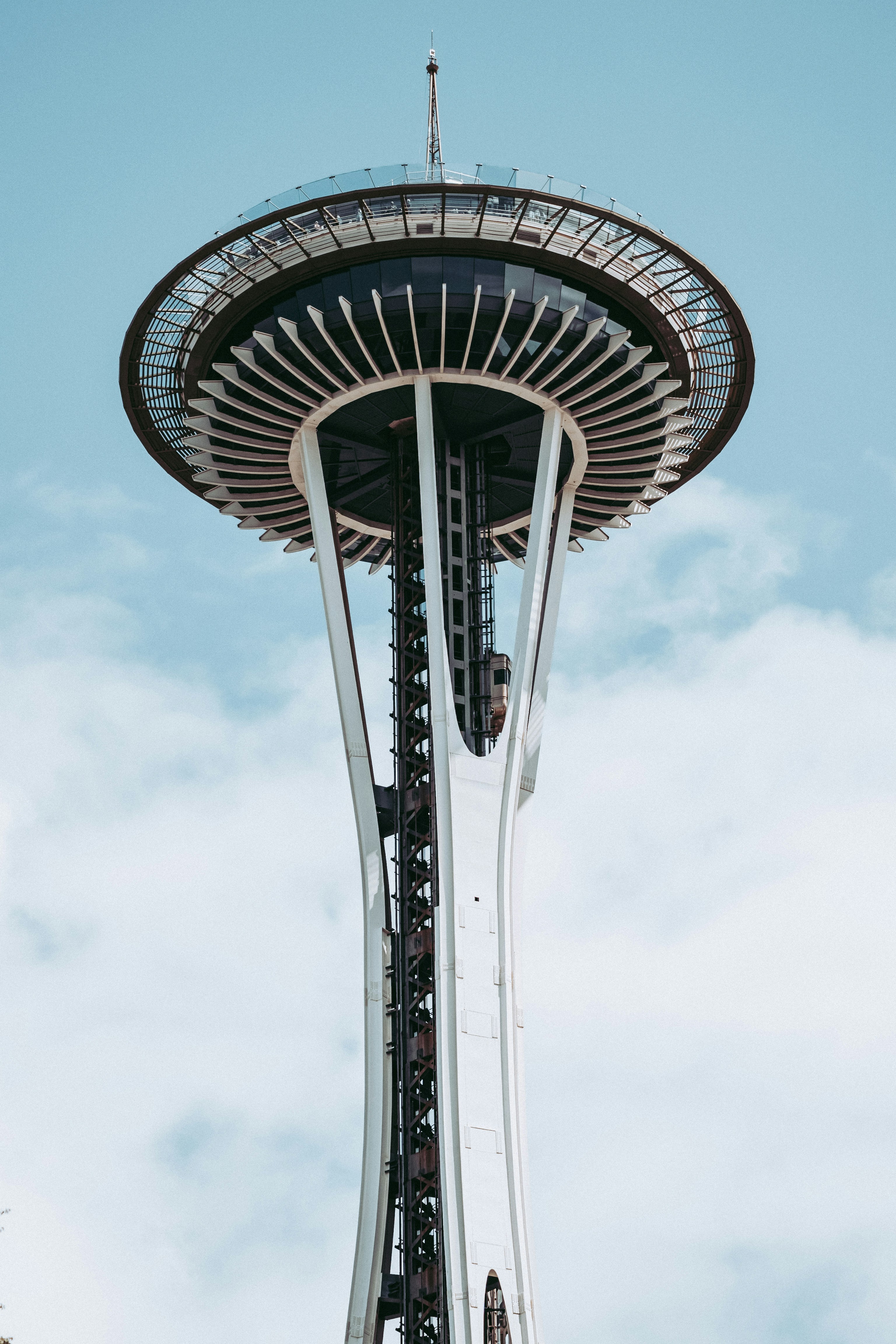 The Space Needle observation tower against a blue sky with light clouds in Seattle