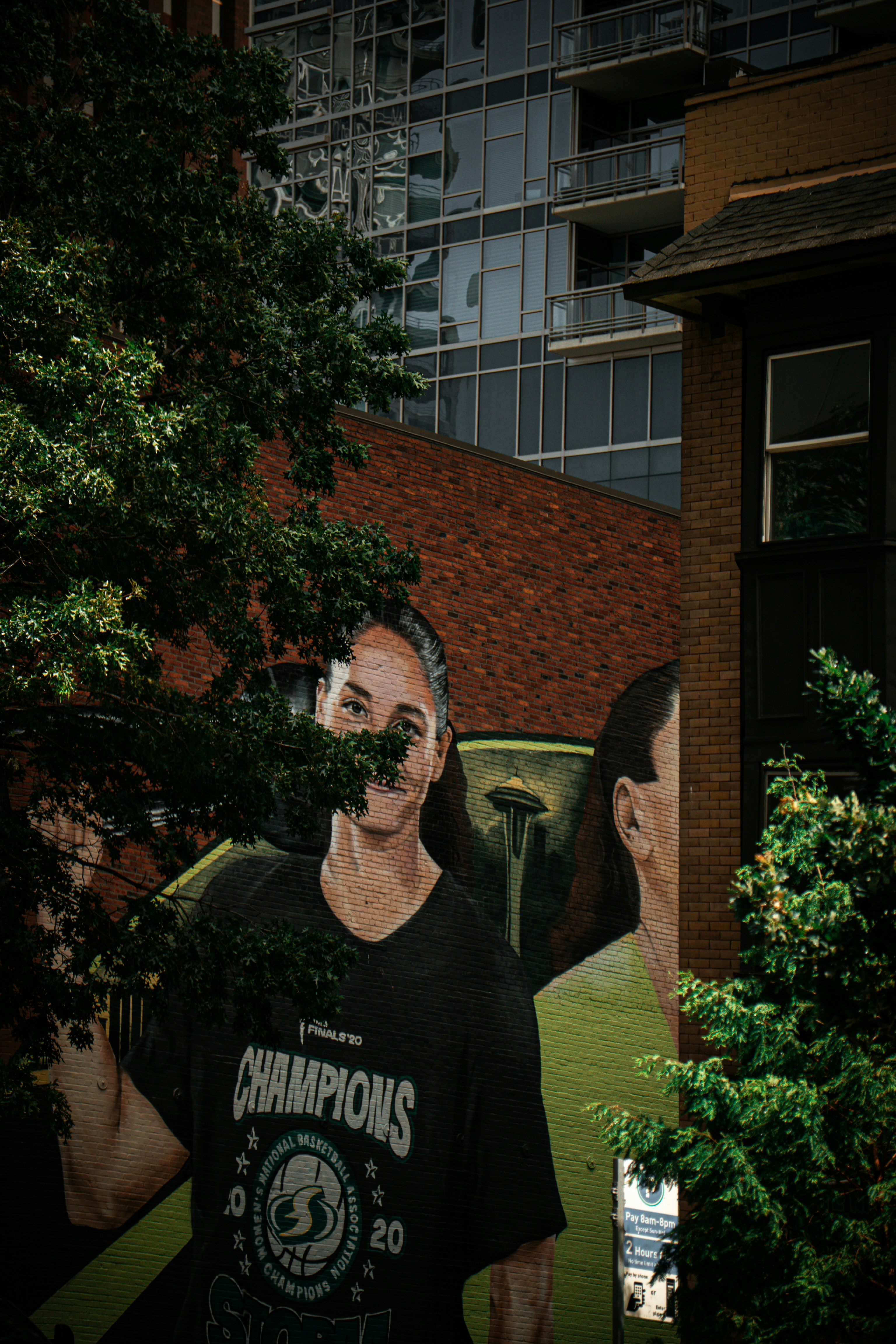 A mural of a basketball player on a brick wall in Seattle