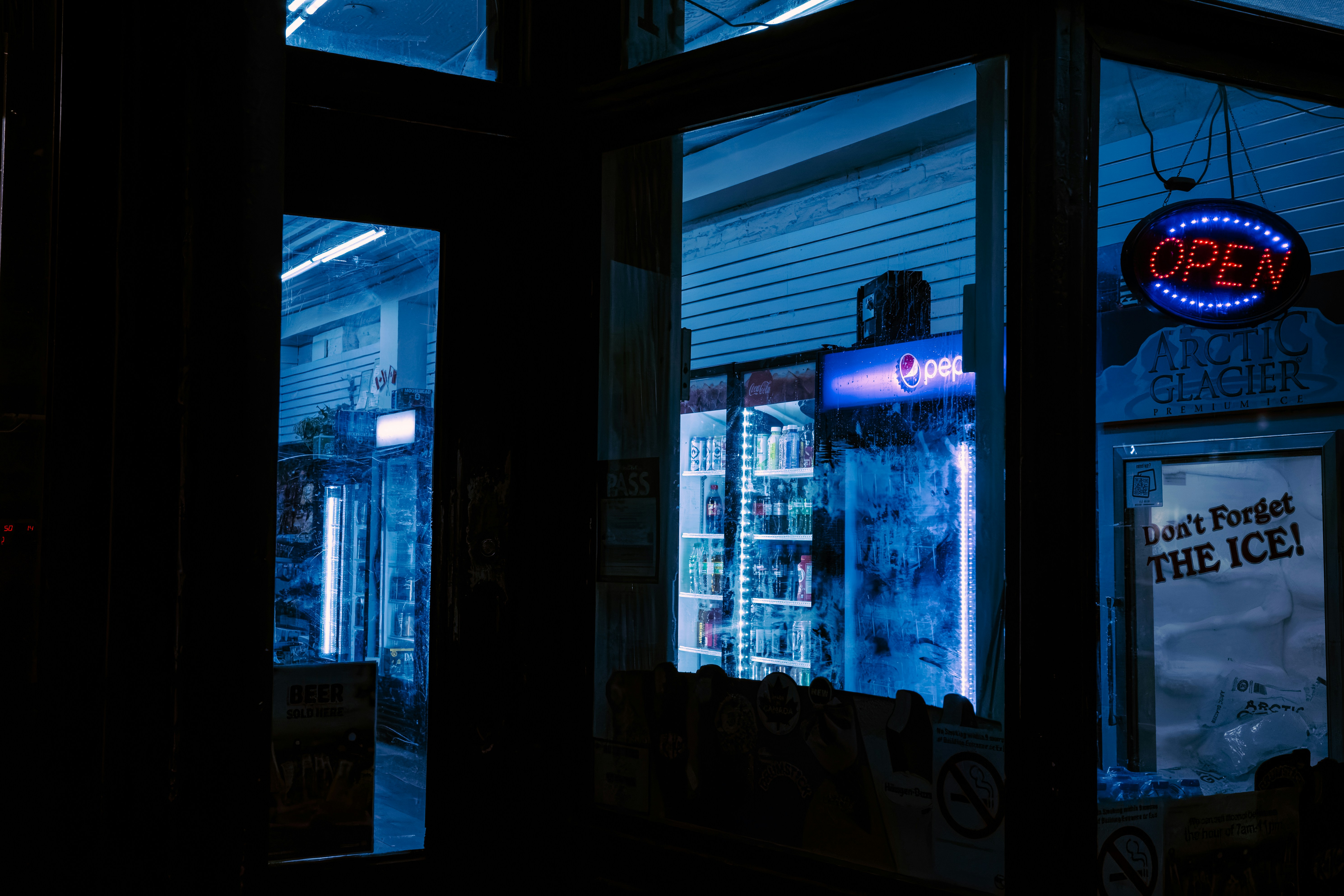 Convenience store interior with an open sign at night