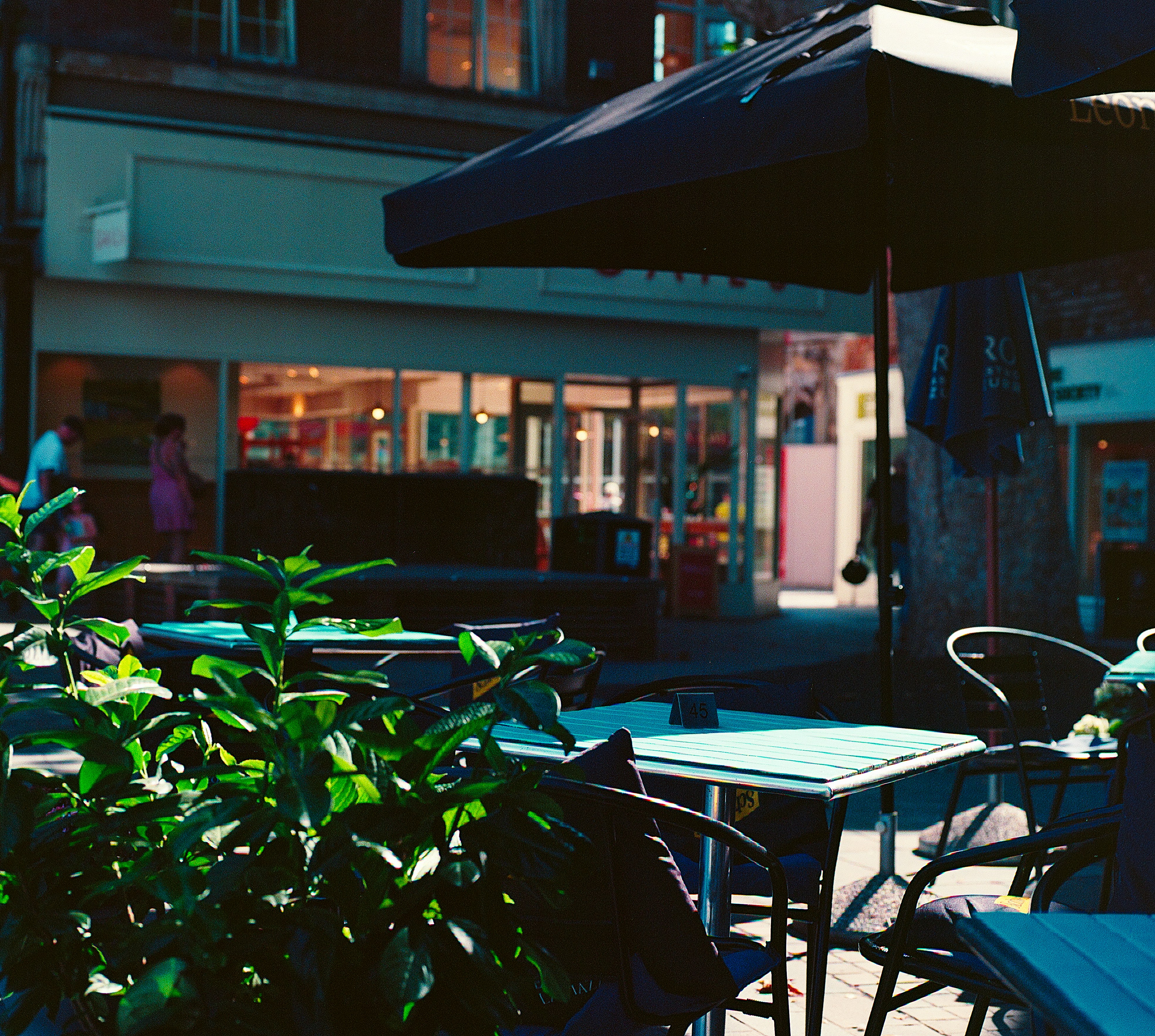 Café tables on a European street — correspondence after the road
