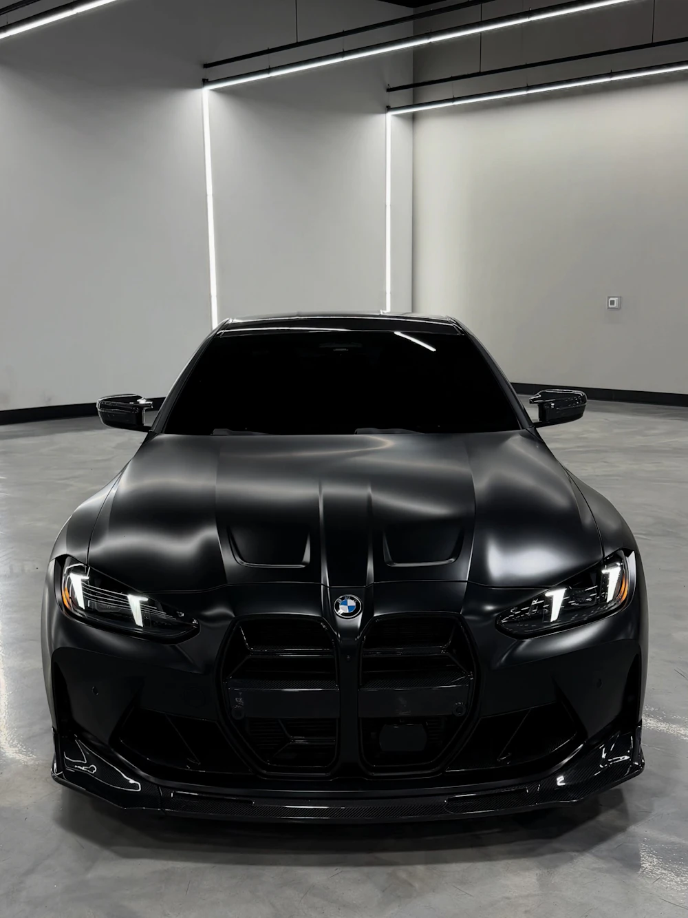 Matte black BMW in a lit garage