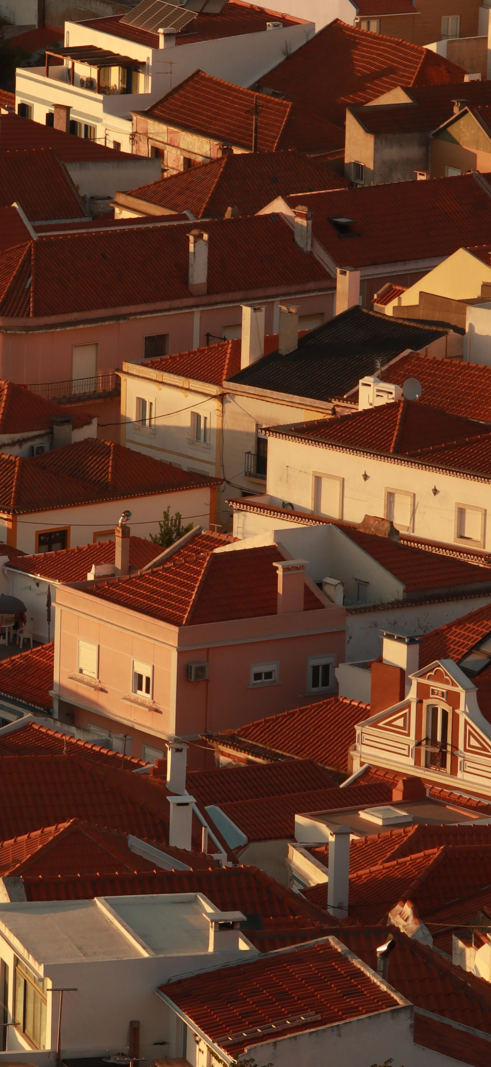 Terracotta rooftops of a European town in golden light