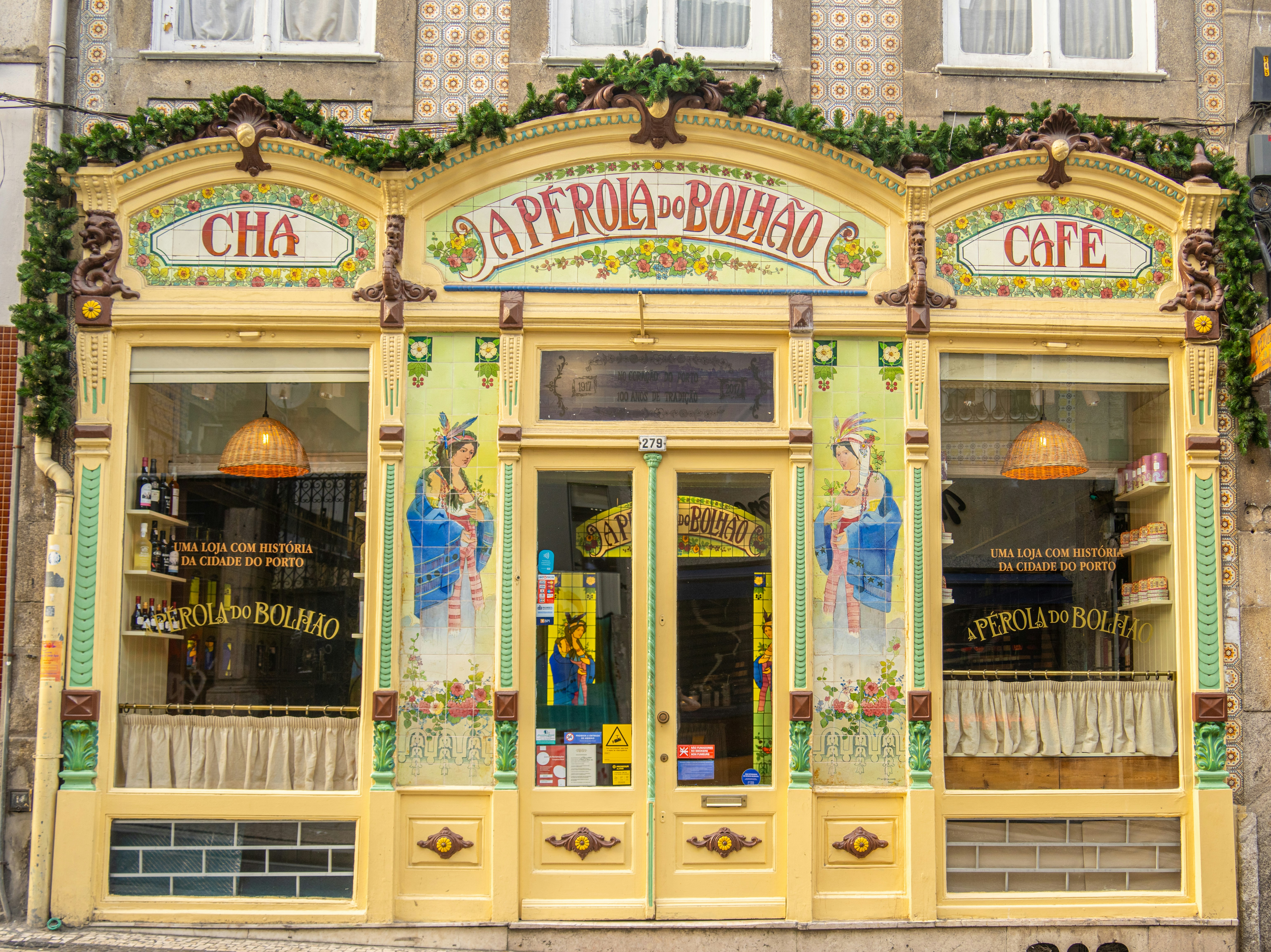 The ornate yellow facade of A Pérola do Bolhão shop in Porto, Portugal