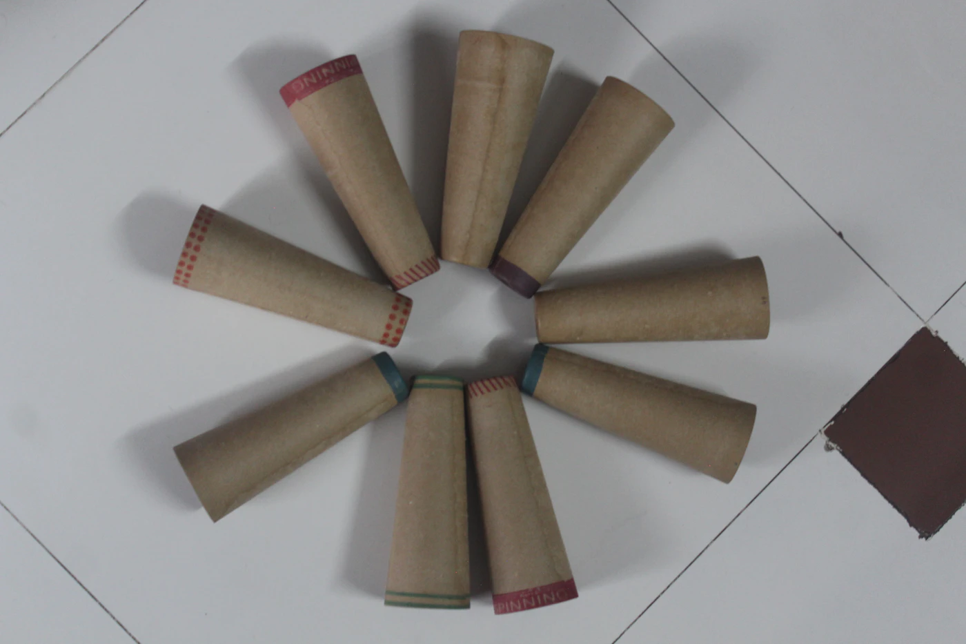 DIY confetti toss cones for ceremonies — Finished paper cones filled with flower petals wait in a wooden basket for guests.