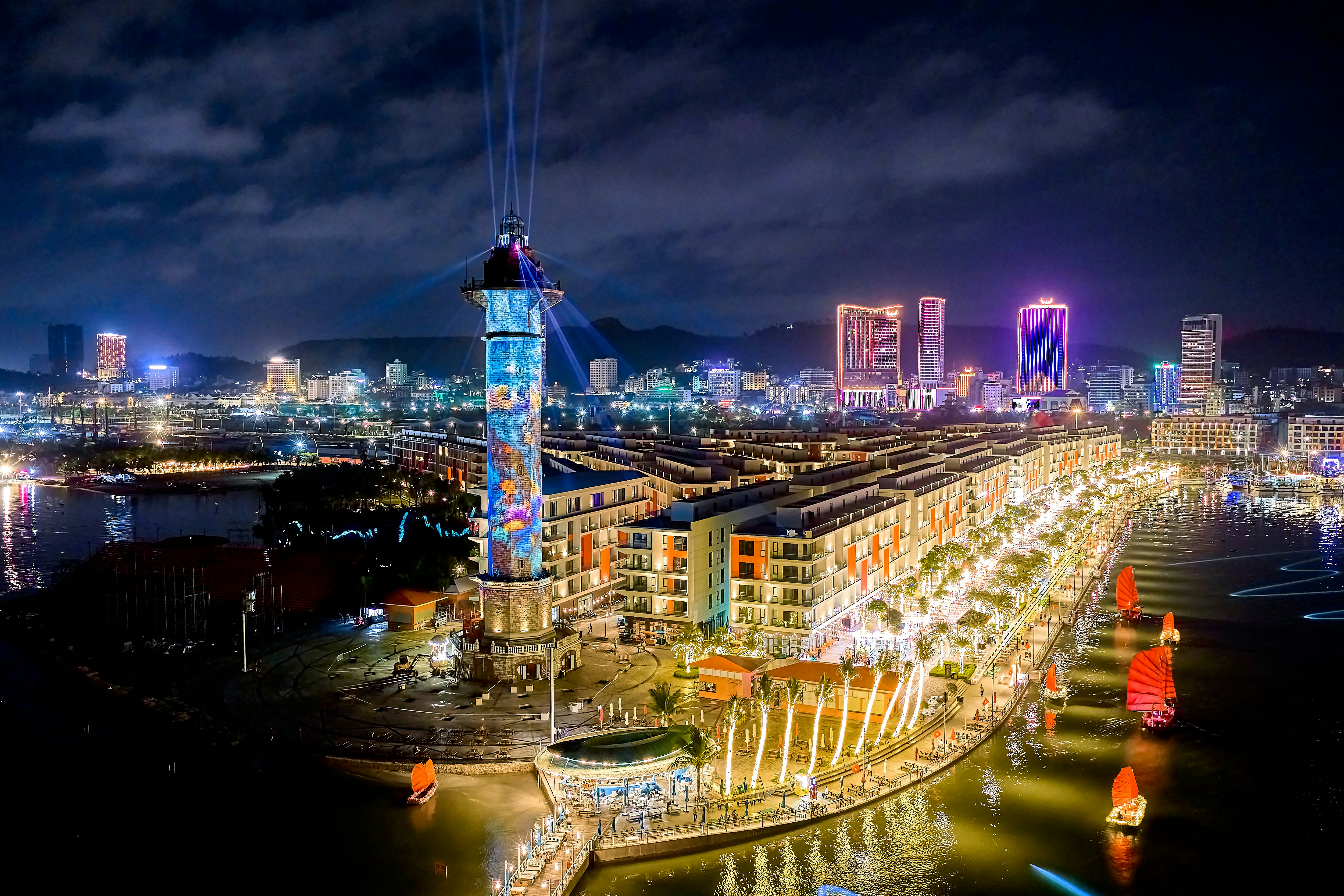 Aerial view of a illuminated lighthouse tower and waterfront buildings in Phu Quoc, Vietnam