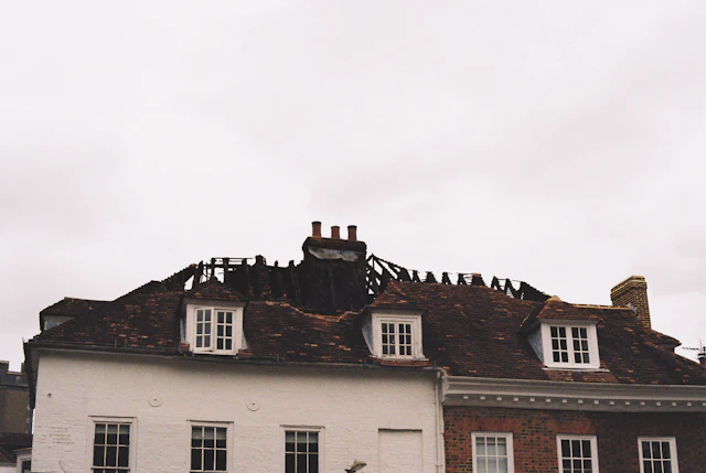 House with a fire-damaged roof and exposed rafters