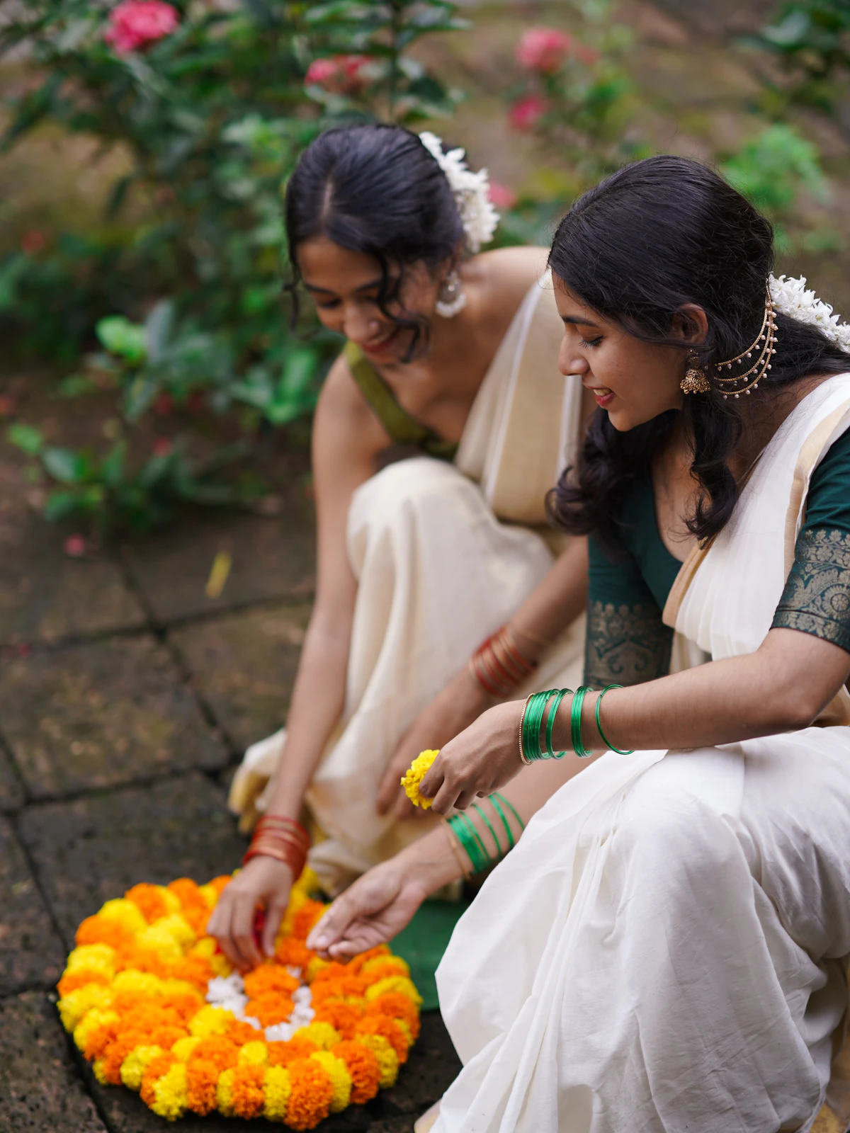 Women arranging marigold flowers for a celebration in India (representative image)
