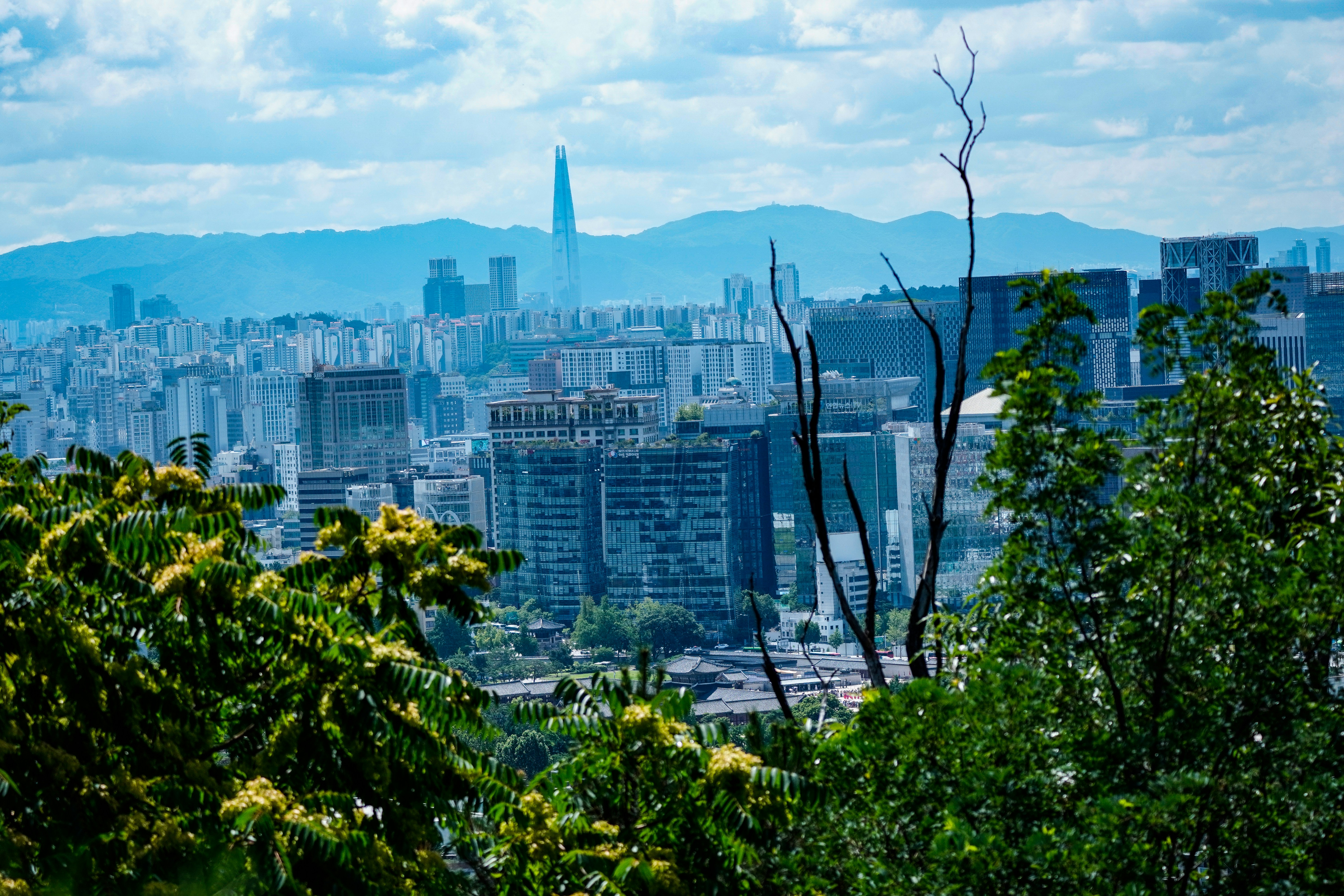 The Lotte World Tower rising above the Seoul skyline under a blue sky