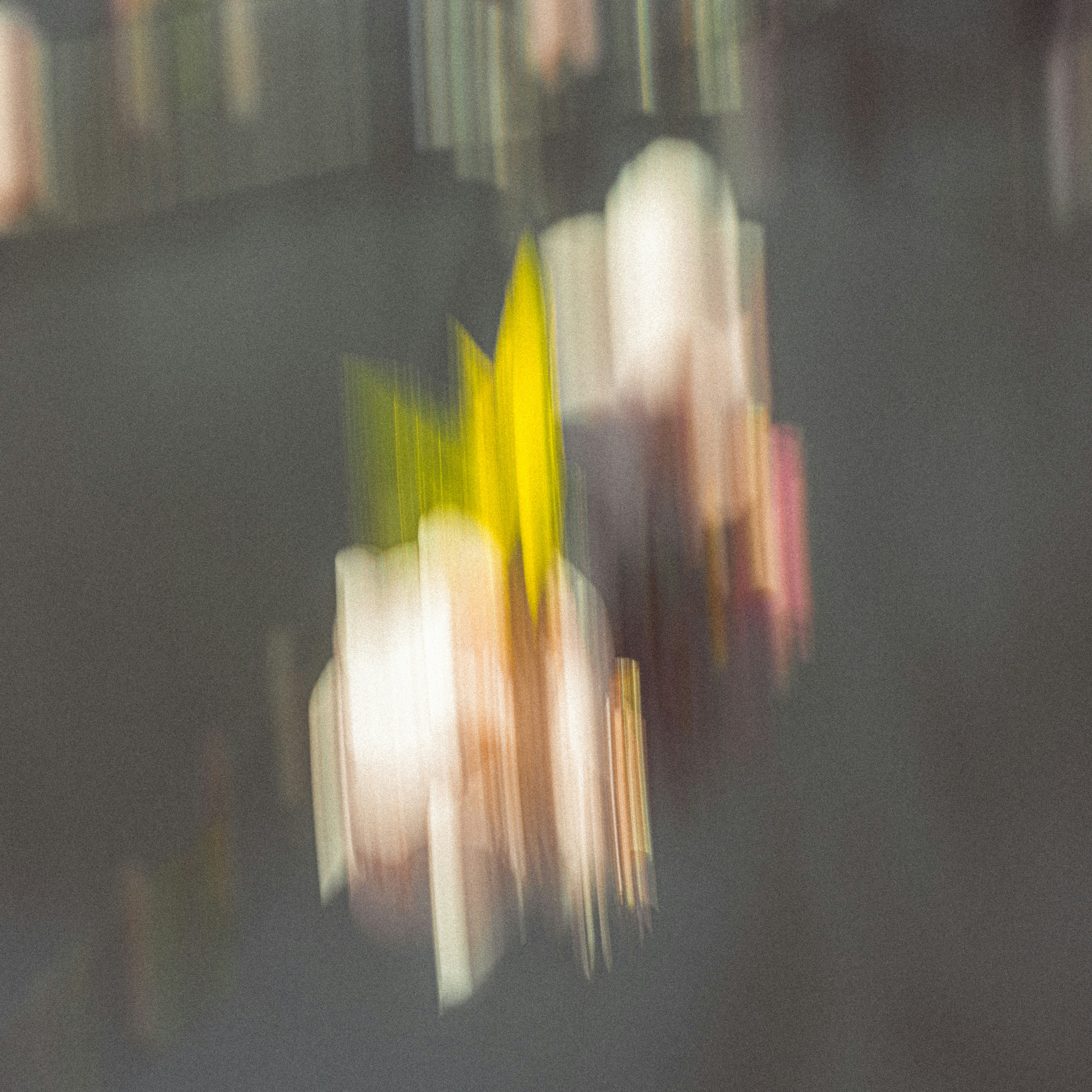 Abstract motion blur with streaks of yellow and white on a dark background