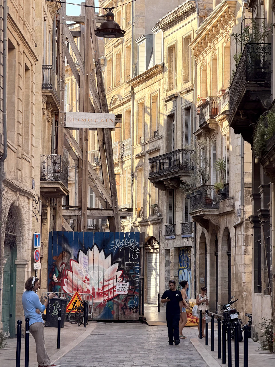 Street art on historic stone buildings in Bordeaux