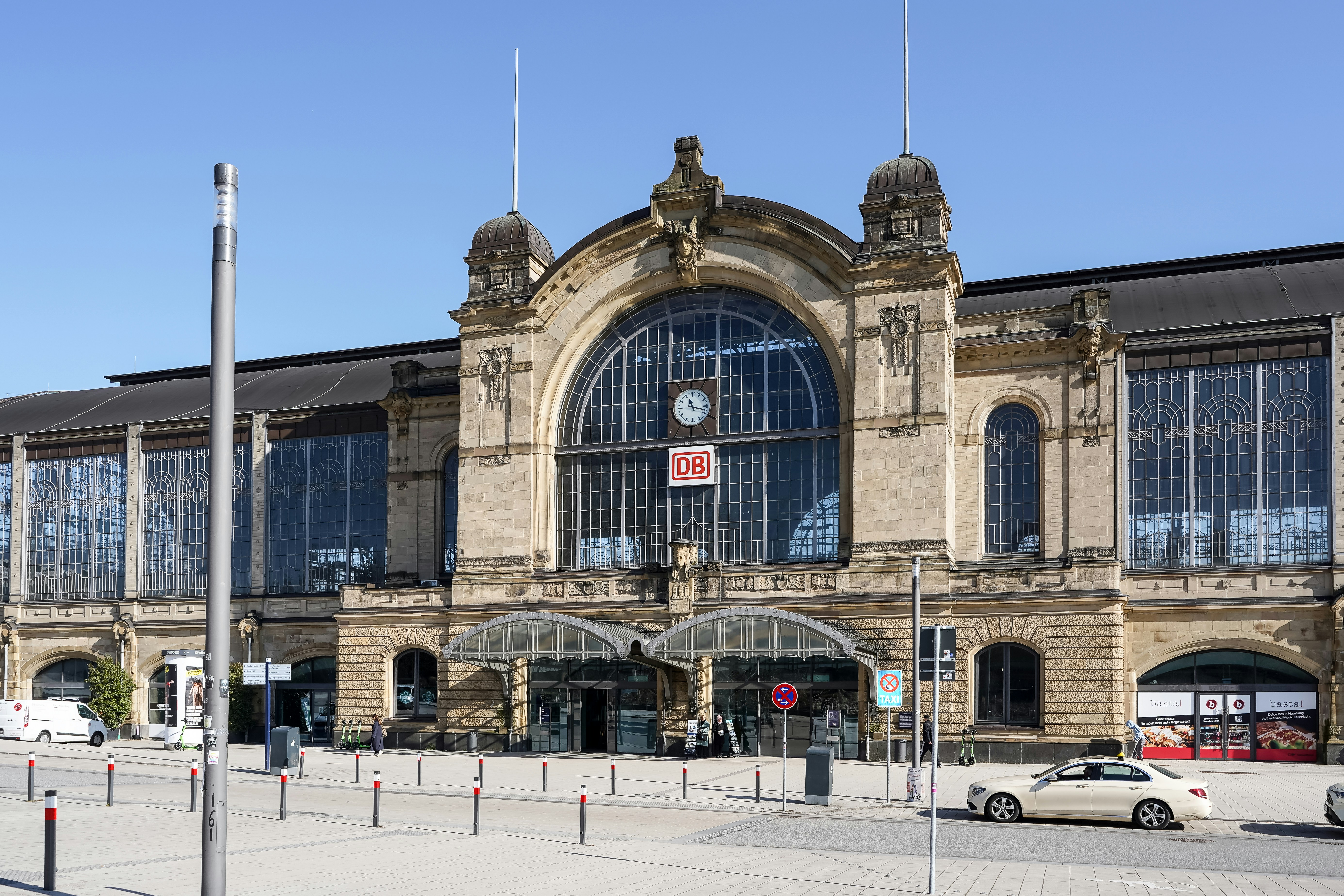 The historic stone facade of the Metz railway station with a large arched window