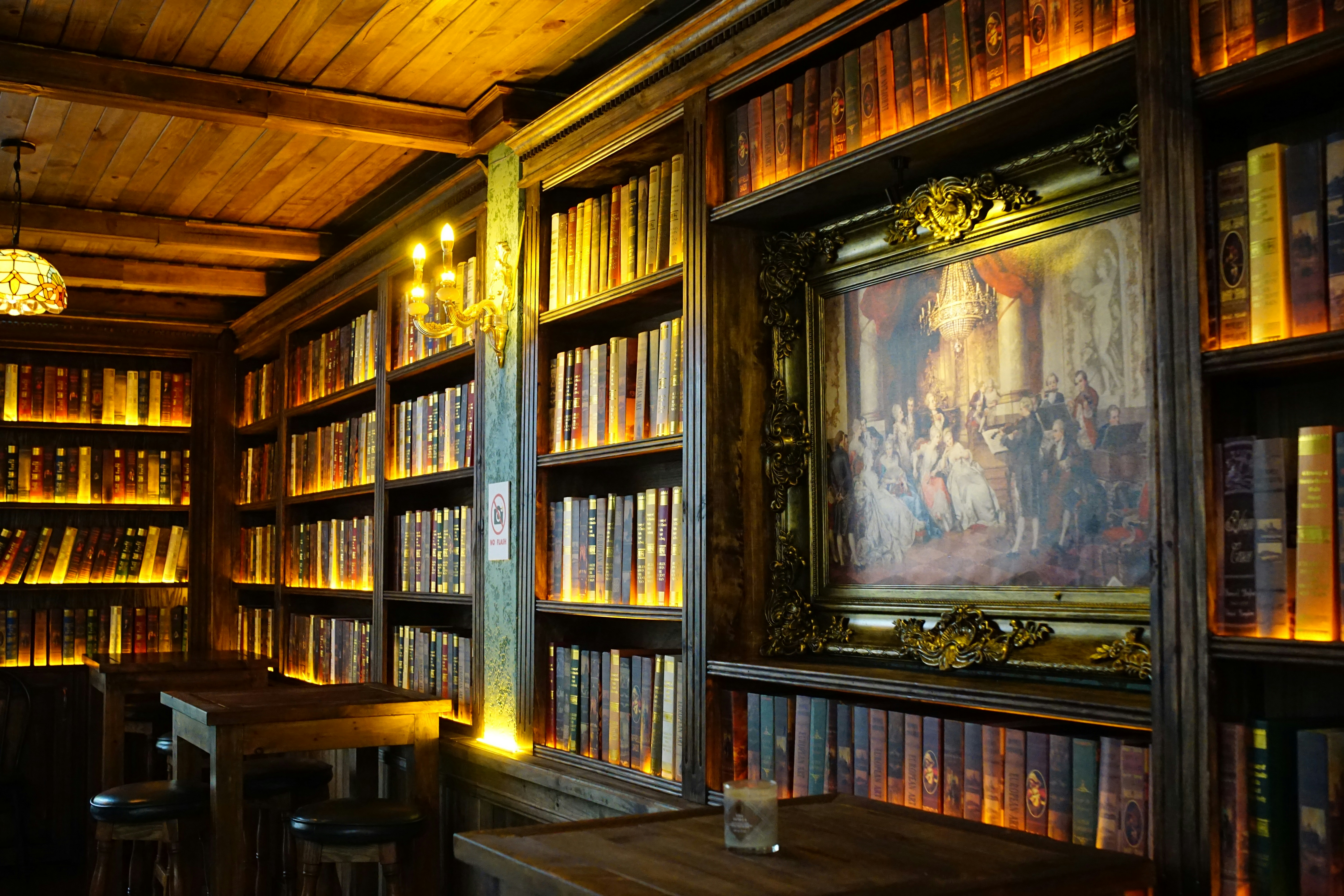Warmly lit library with wooden shelves