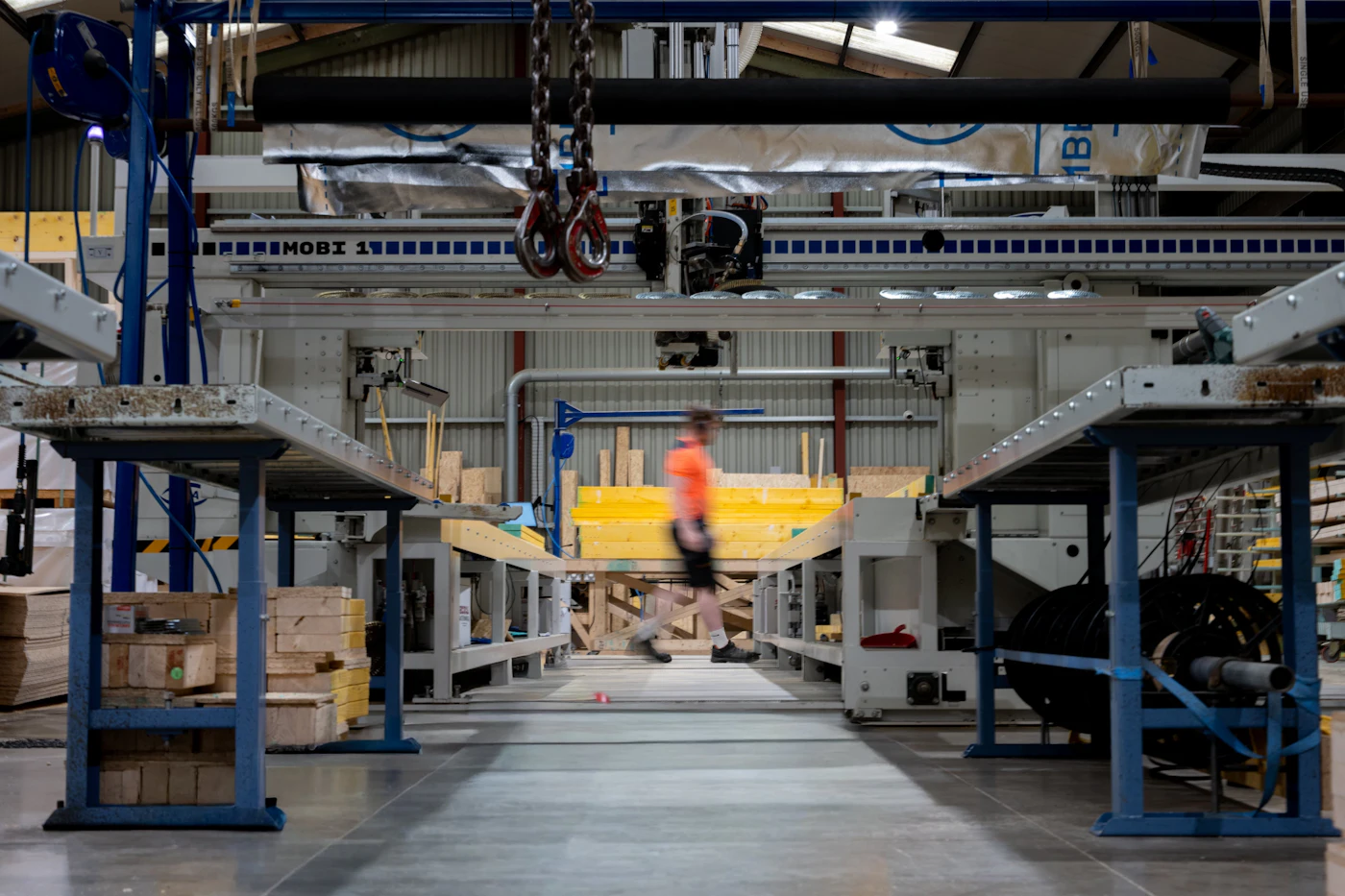 A professional walking through an industrial operations floor