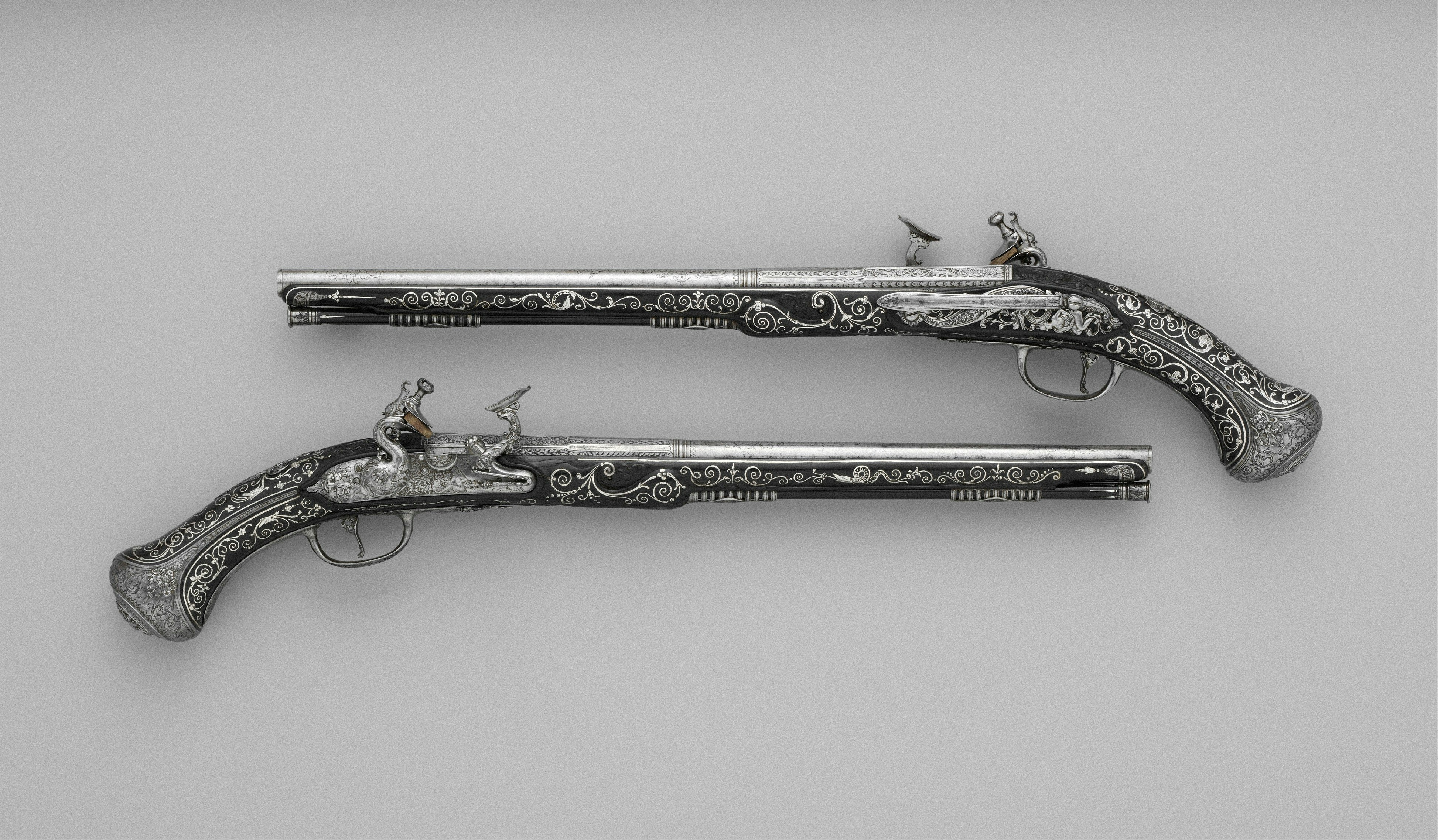 Title: Pair of Snaphaunce Pistols,Gunsmith: Matteo Cecchi, called Acquafresca (Italian, Bargi, 1651–1738),Barrelsmith: Giovan Battista Francino (Italian, Brescia, active second half of 17th century),Date: ca. 1690,Geography: Bargi,Culture: Italian, Bargi,Medium: Steel, silver, wood (ebony),Dimensions: L. of each pistol 21 1/2 in. (54.7 cm); L. of each barrel 15 in. (38.2 cm); Cal. of each barrel 1/2 in. (13 mm),Classification: Firearms-Pistols-Snaphaunce,Credit Line: Purchase, Arthur Ochs Sulzberger Gift, 2006,Object Number: 2006.471.1, .2. http://www.metmuseum.org/art/collection/search/34183
