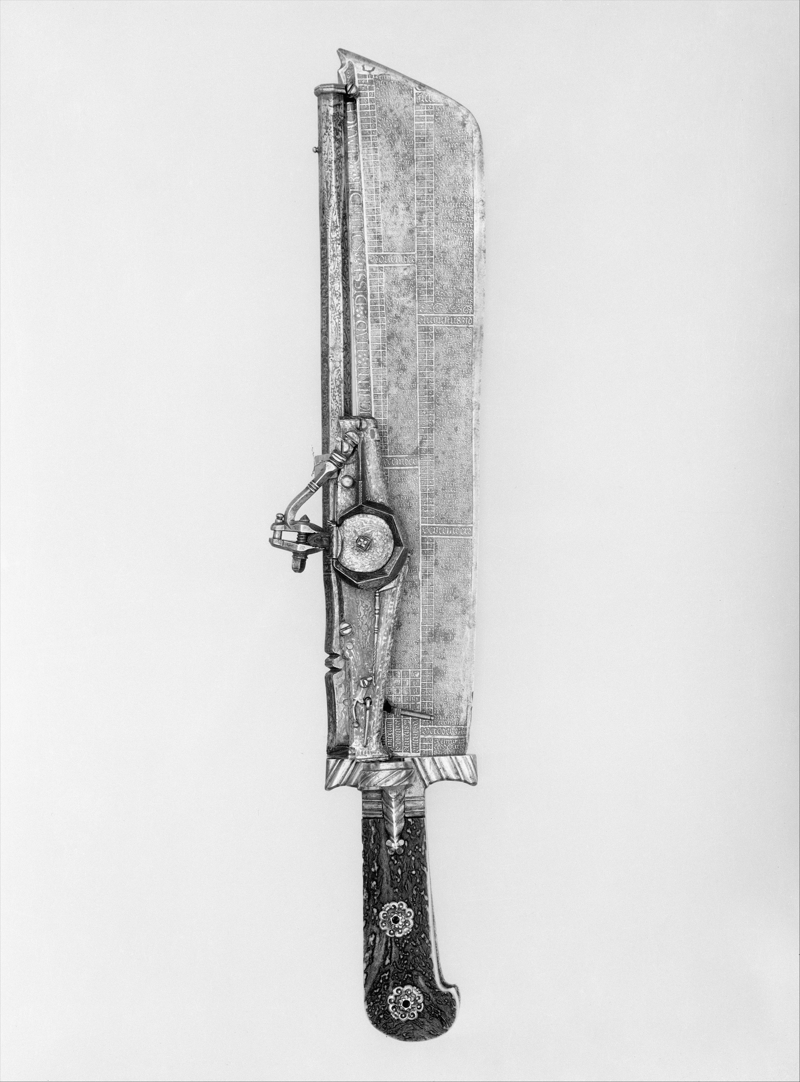 A metal knife with a calendar engraved on the blade and a staghorn handle