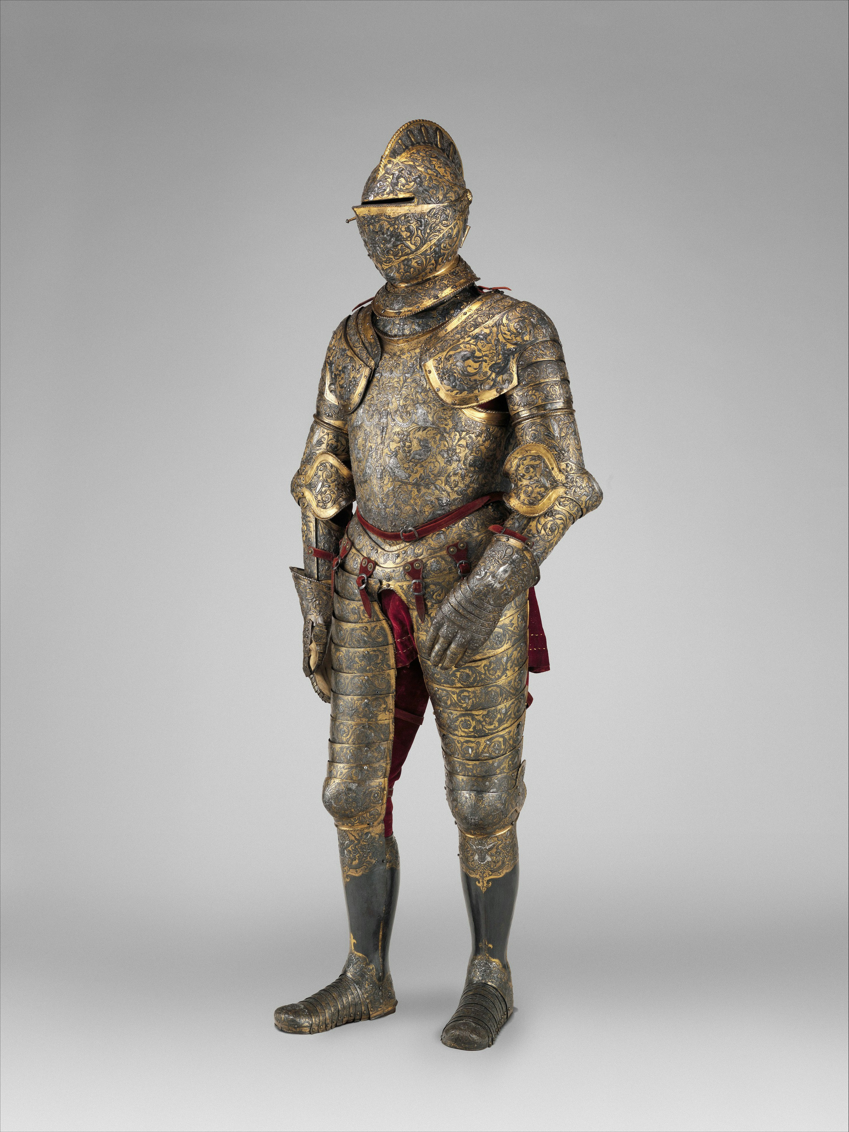 A suit of ornate gold and steel armor with intricate floral engravings