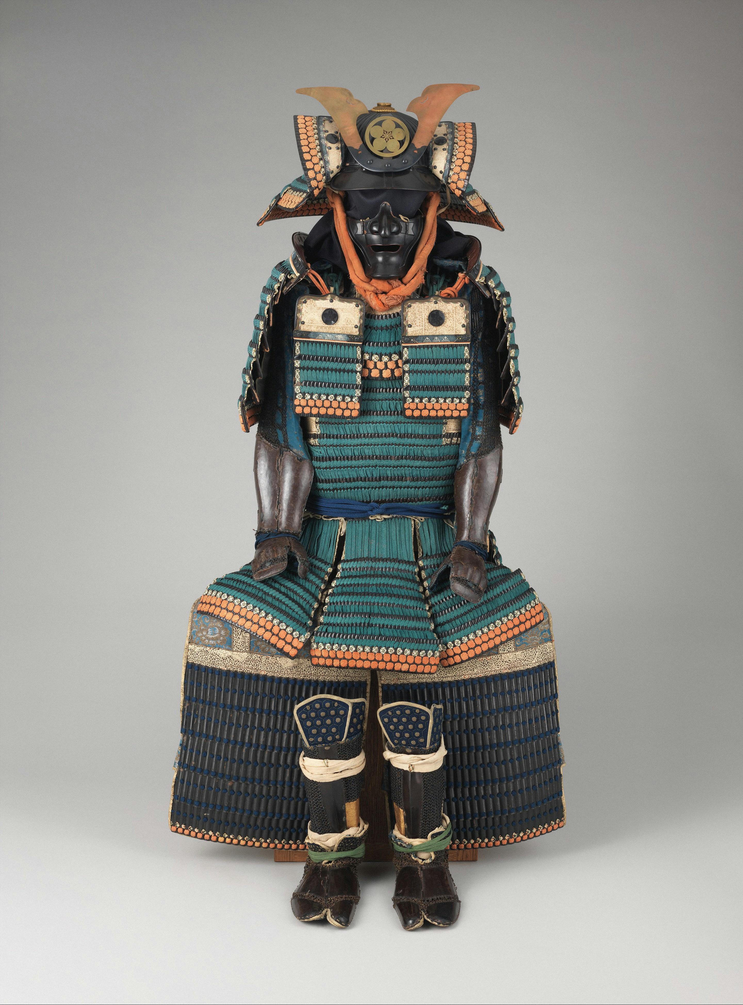 A traditional Japanese samurai armor suit with a teal and orange lacquered chest plate