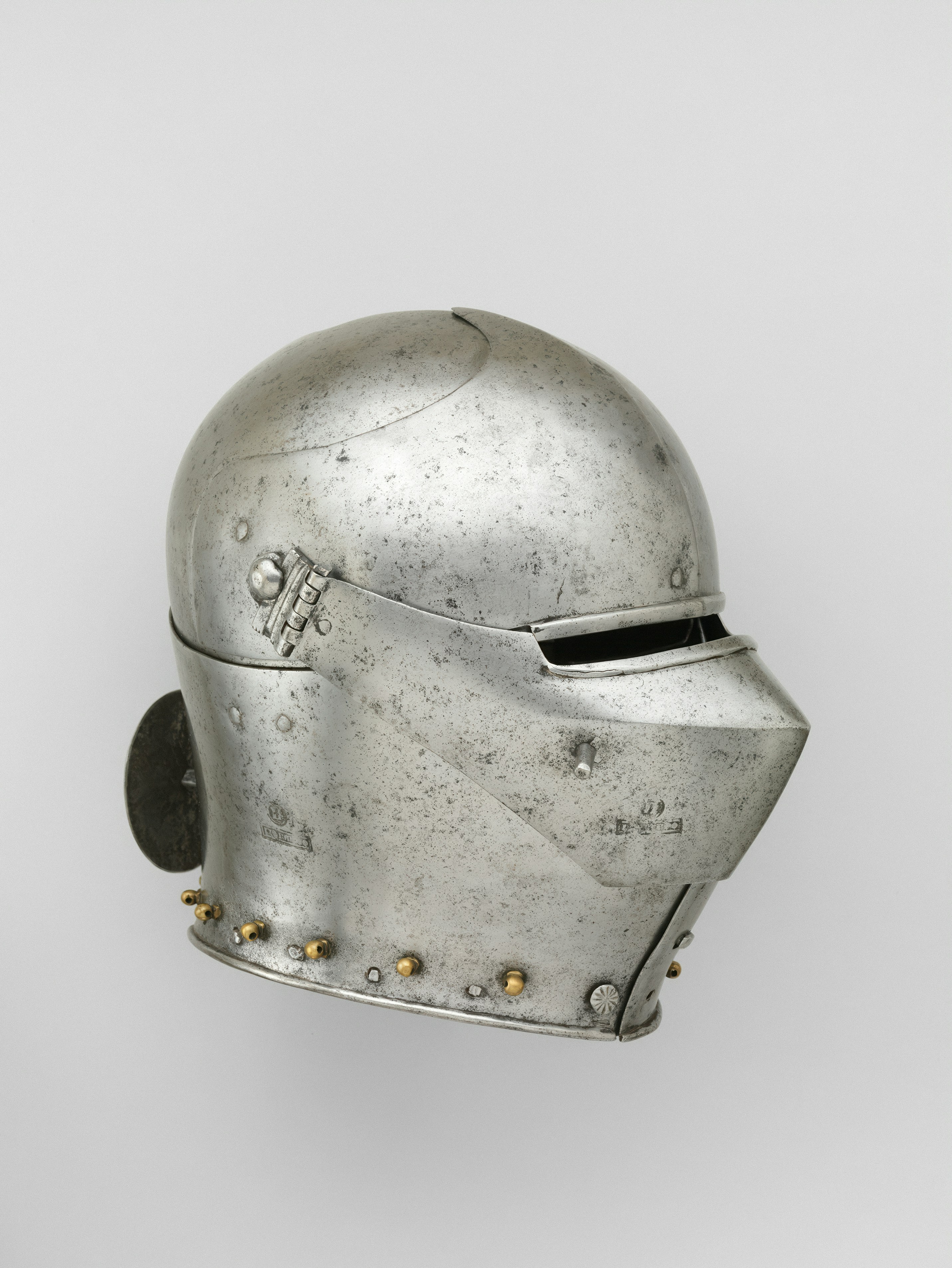 A steel sallet helmet with a narrow visor and brass rivets