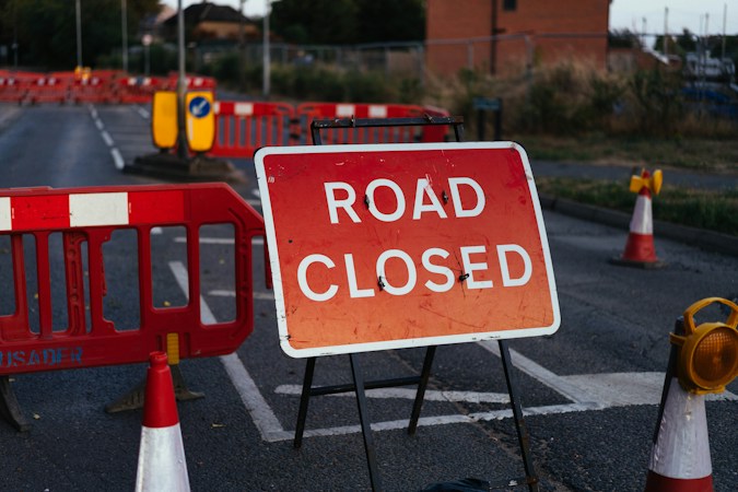 A red road closed sign on a metal stand with orange barriers and traffic cones, like the closure that will keep Commerce Street shut south of Charleston until about Nov. 20