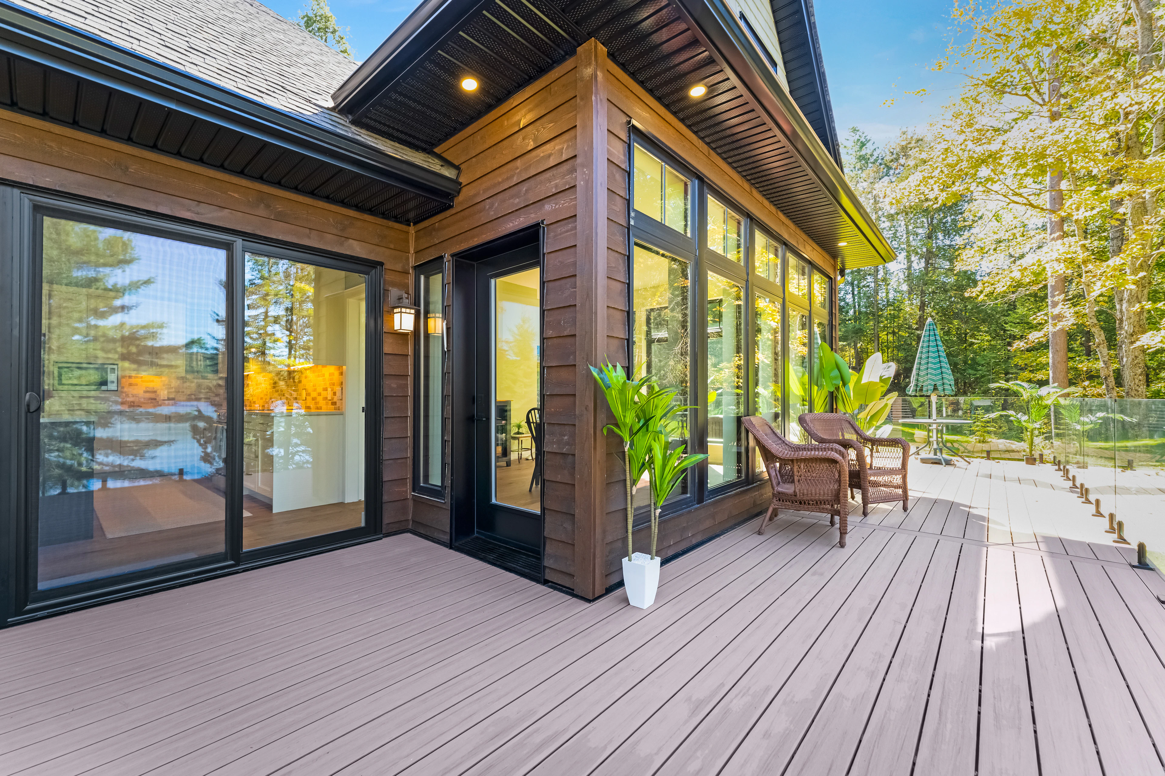 Wooden deck with wicker chairs outside a modern house