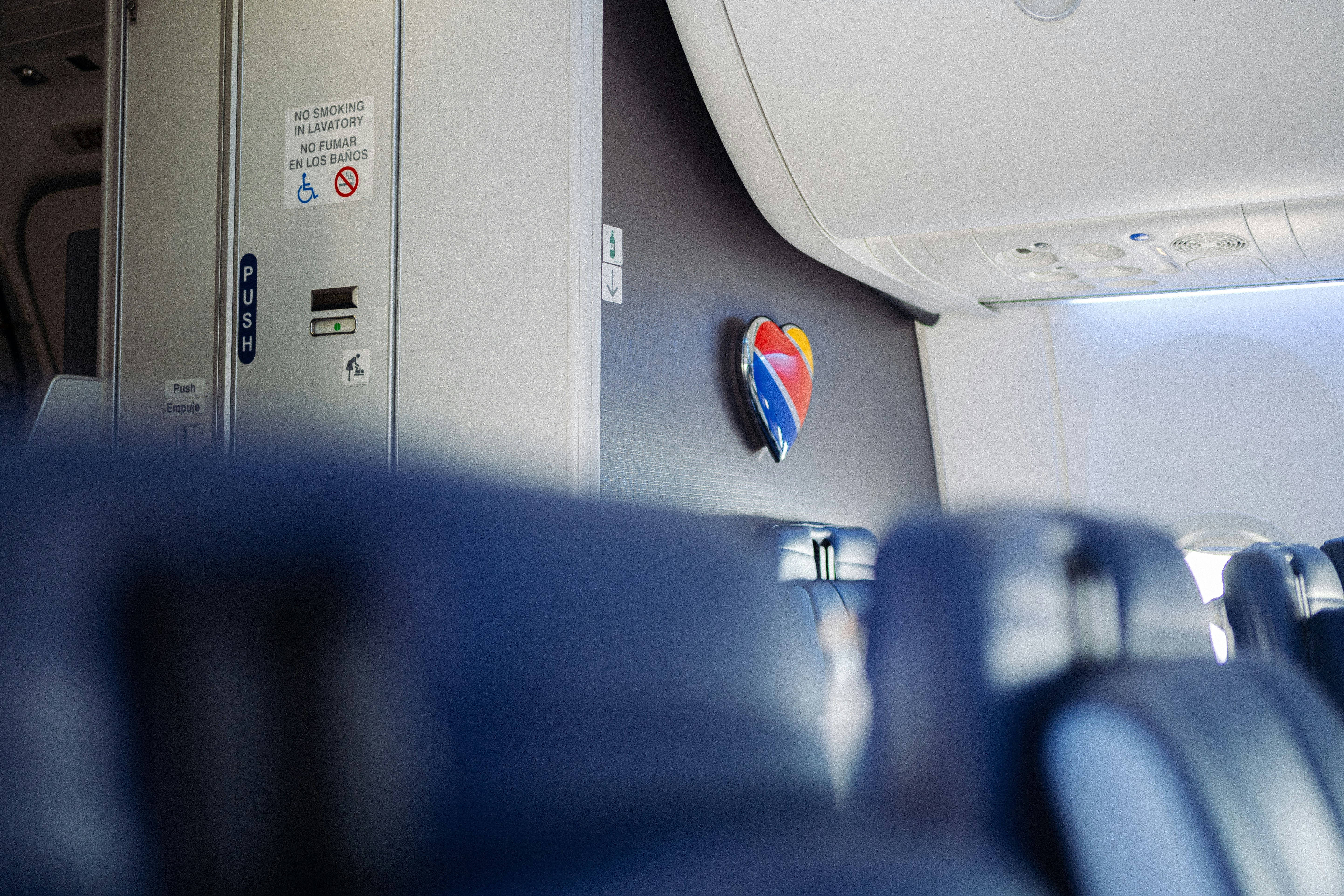 A heart logo on the bulkhead wall inside a commercial airplane cabin