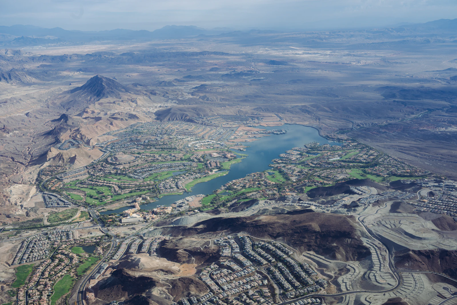 An aerial view of a desert community built around a lake.