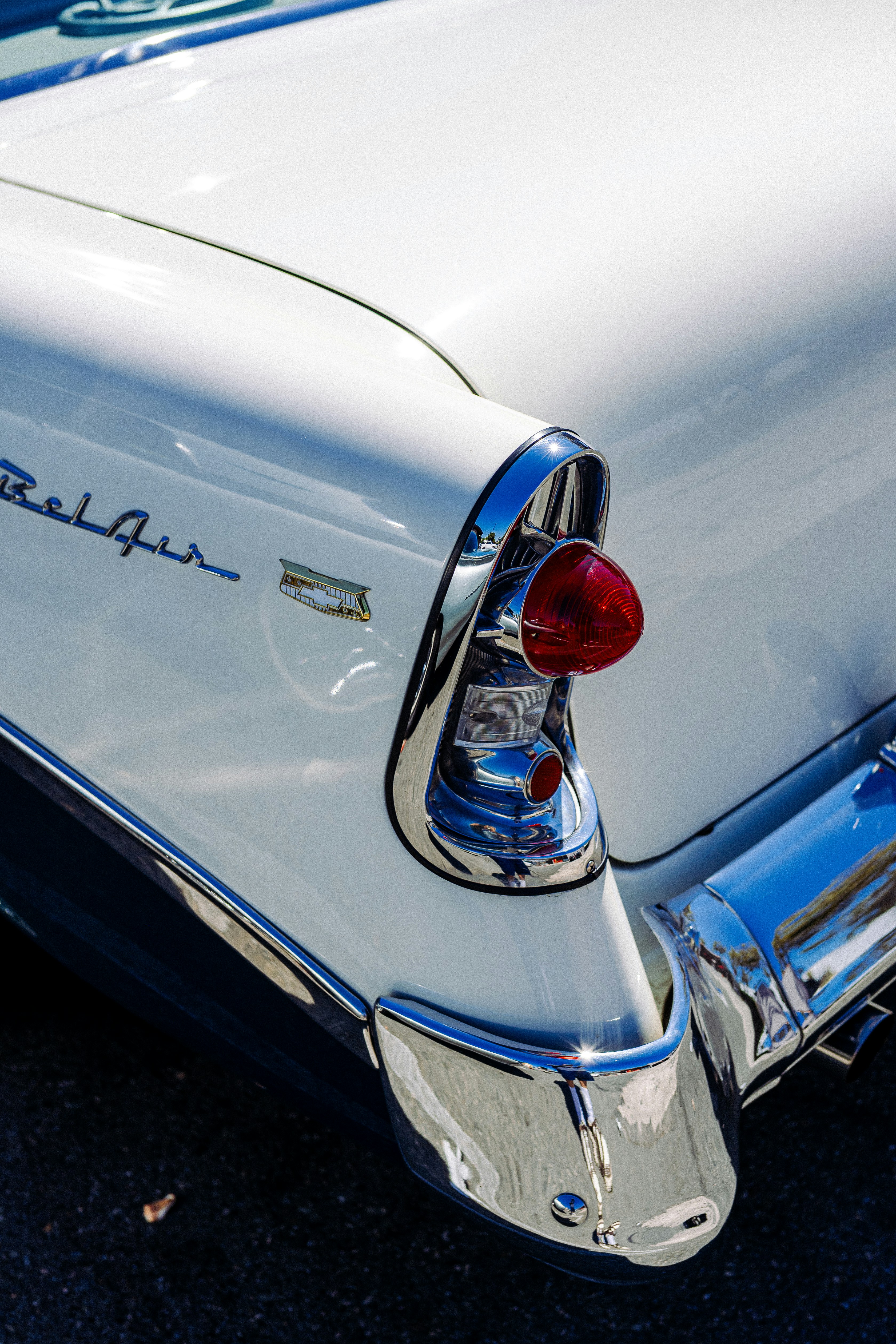 The chrome tail light and white rear fender of a vintage Chevrolet Bel Air
