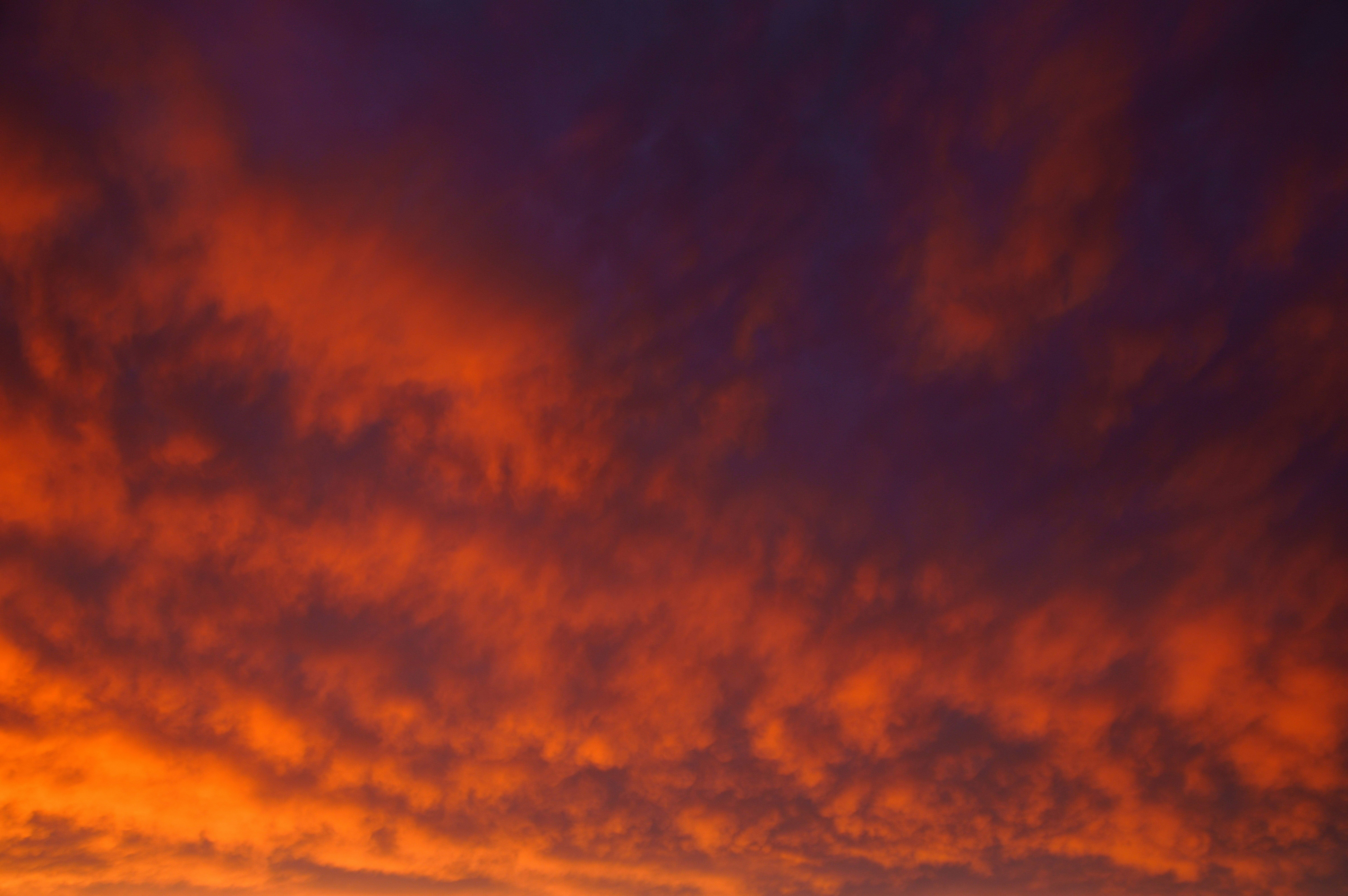 Dense clouds illuminated by a warm orange and deep purple glow