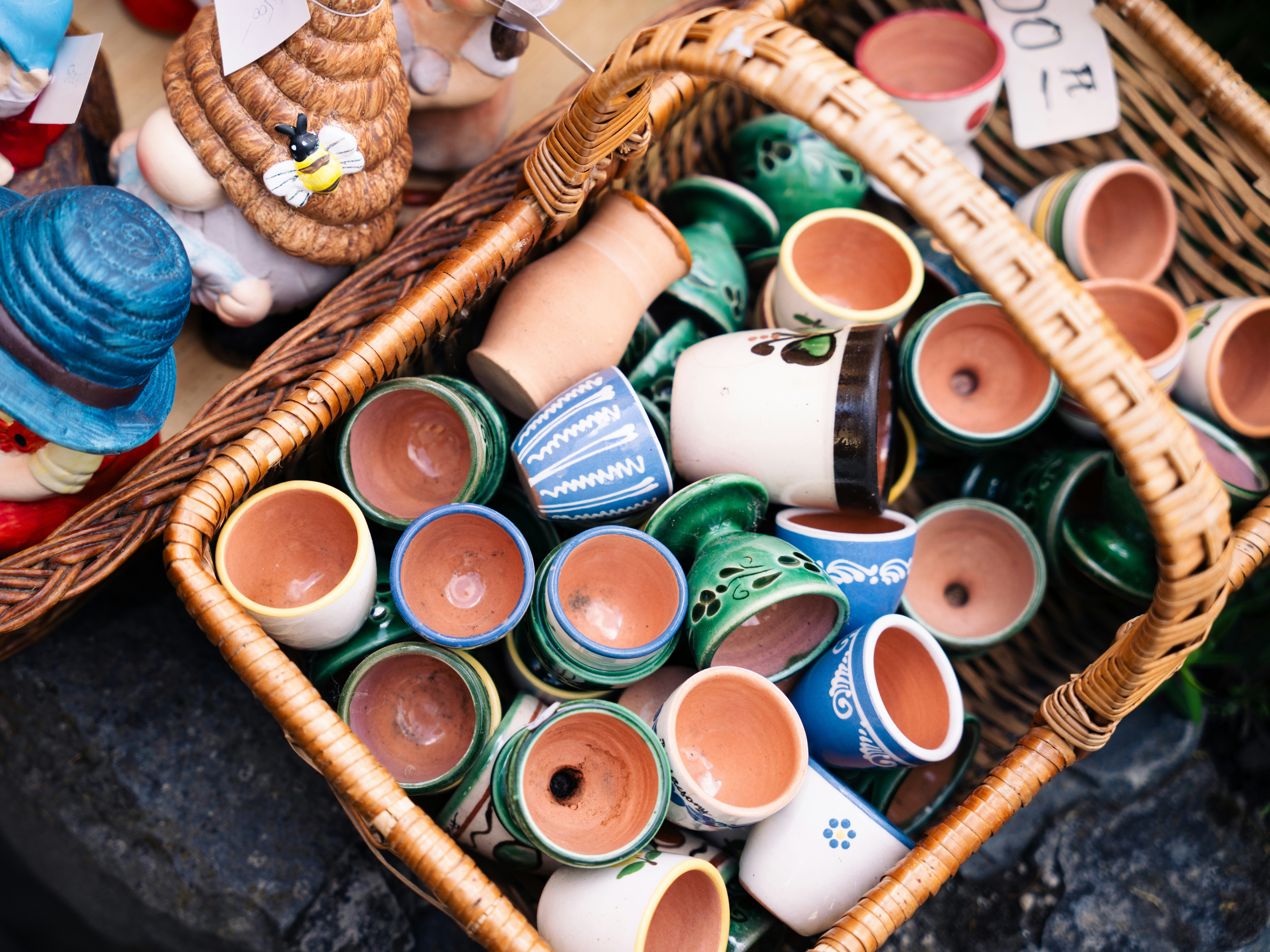Wicker basket of small colourful pots