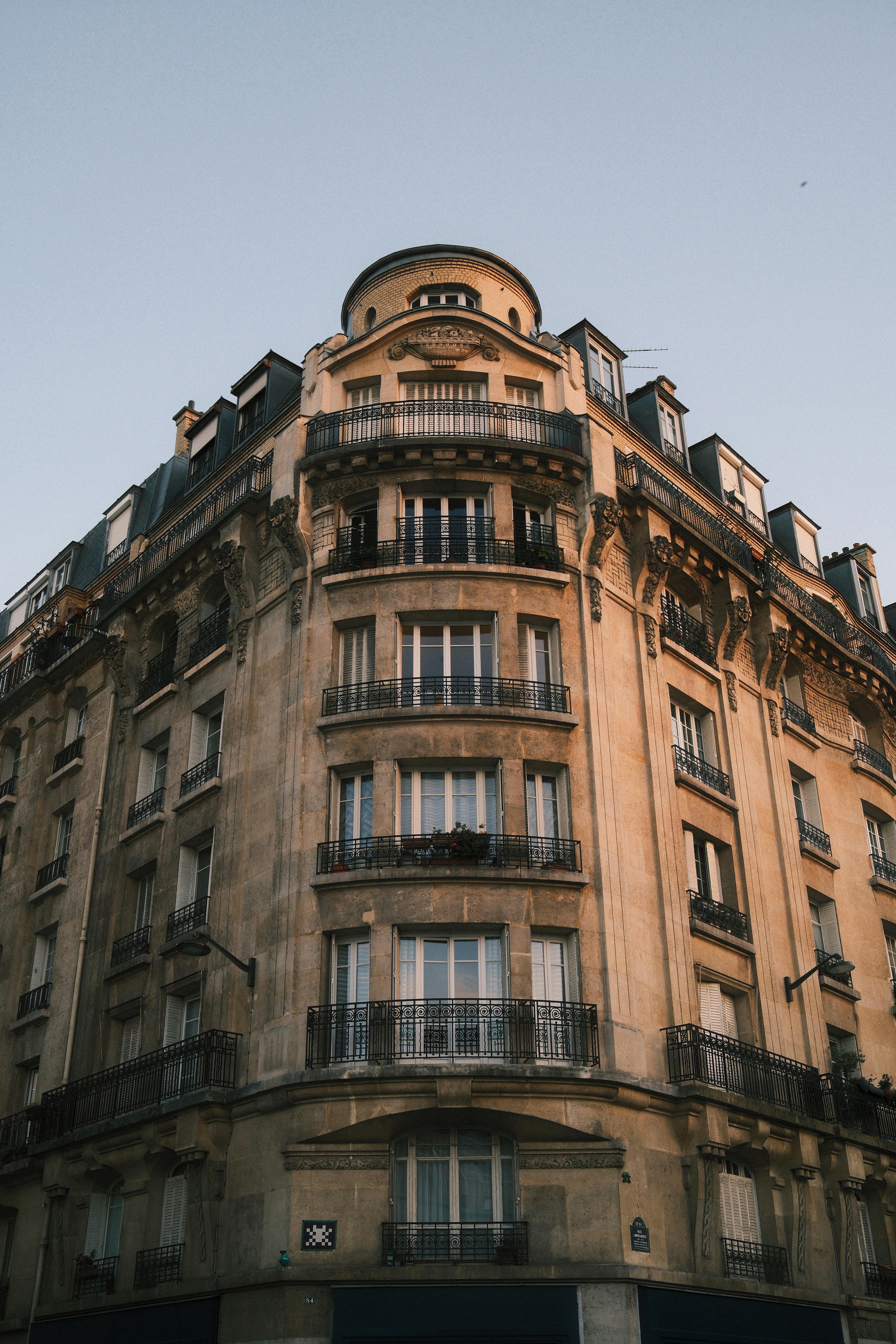 A corner of a Haussmann building in Paris with wrought iron balconies