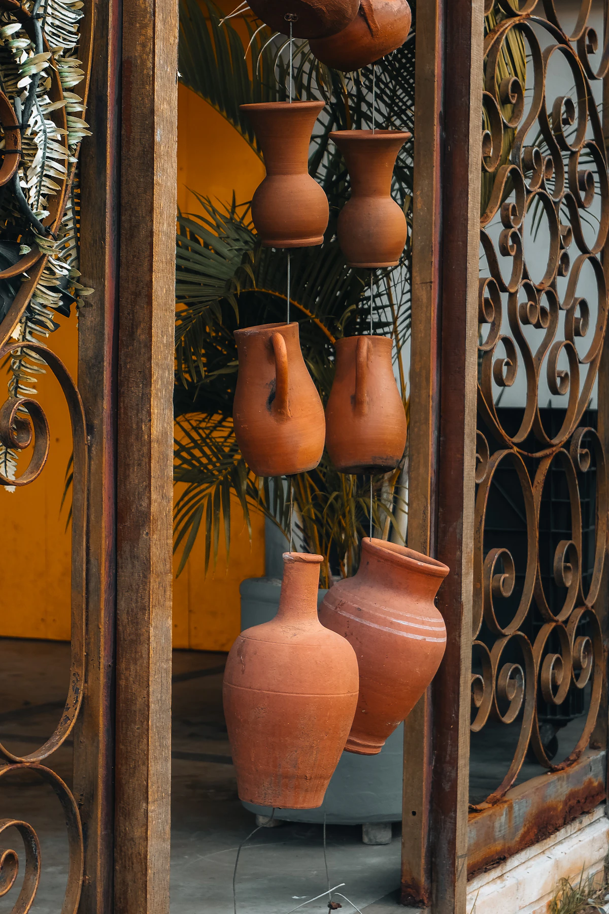 Terracotta clay plant pots grouped near a doorway
